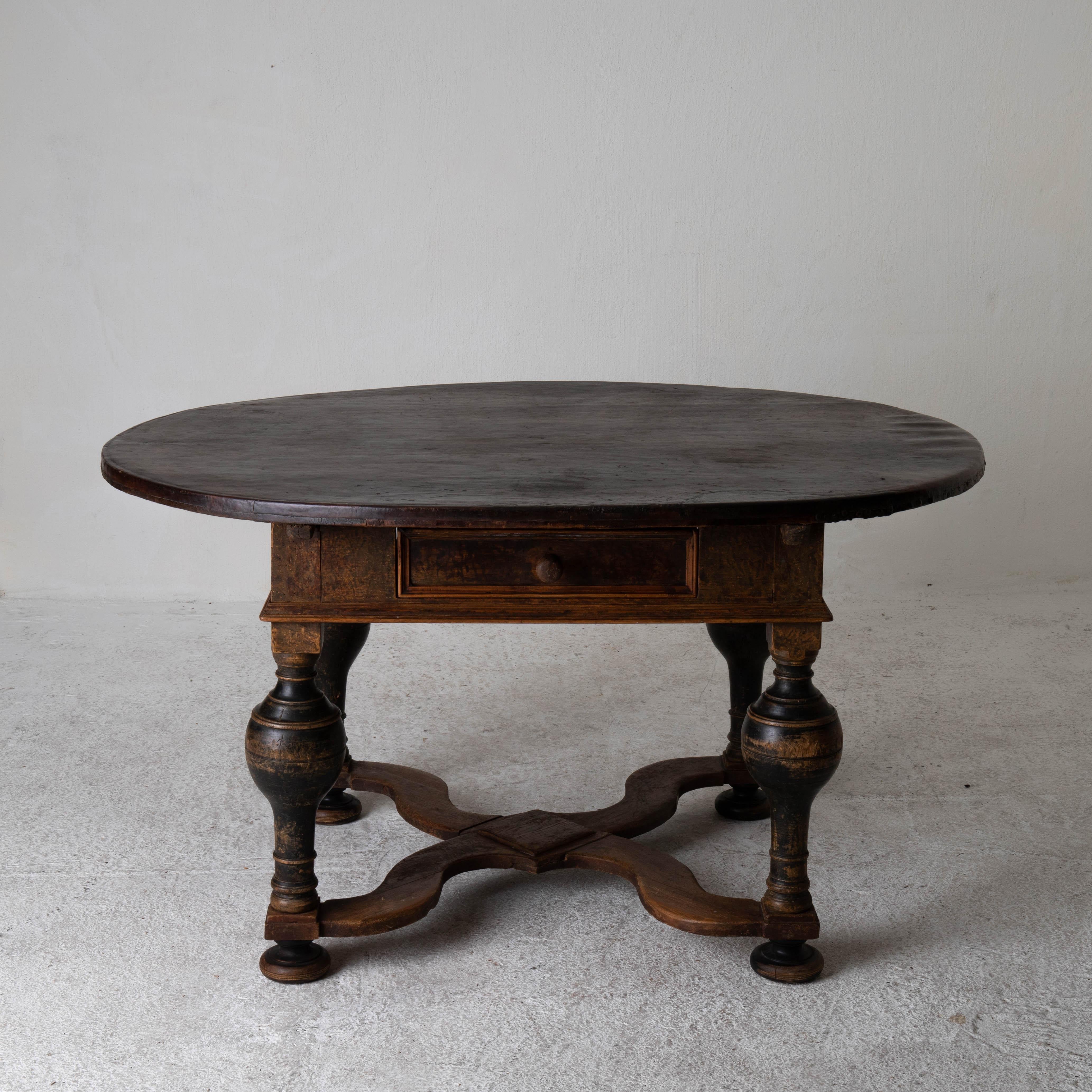 Table rare Swedish Baroque period 1650-1750 leather top Sweden. A table made during the Baroque period 1650-1750 in Sweden. Brass nail heads decorates a part of the edge of the top. Drawer in frieze. Baluster shaped legs that are tied together in a