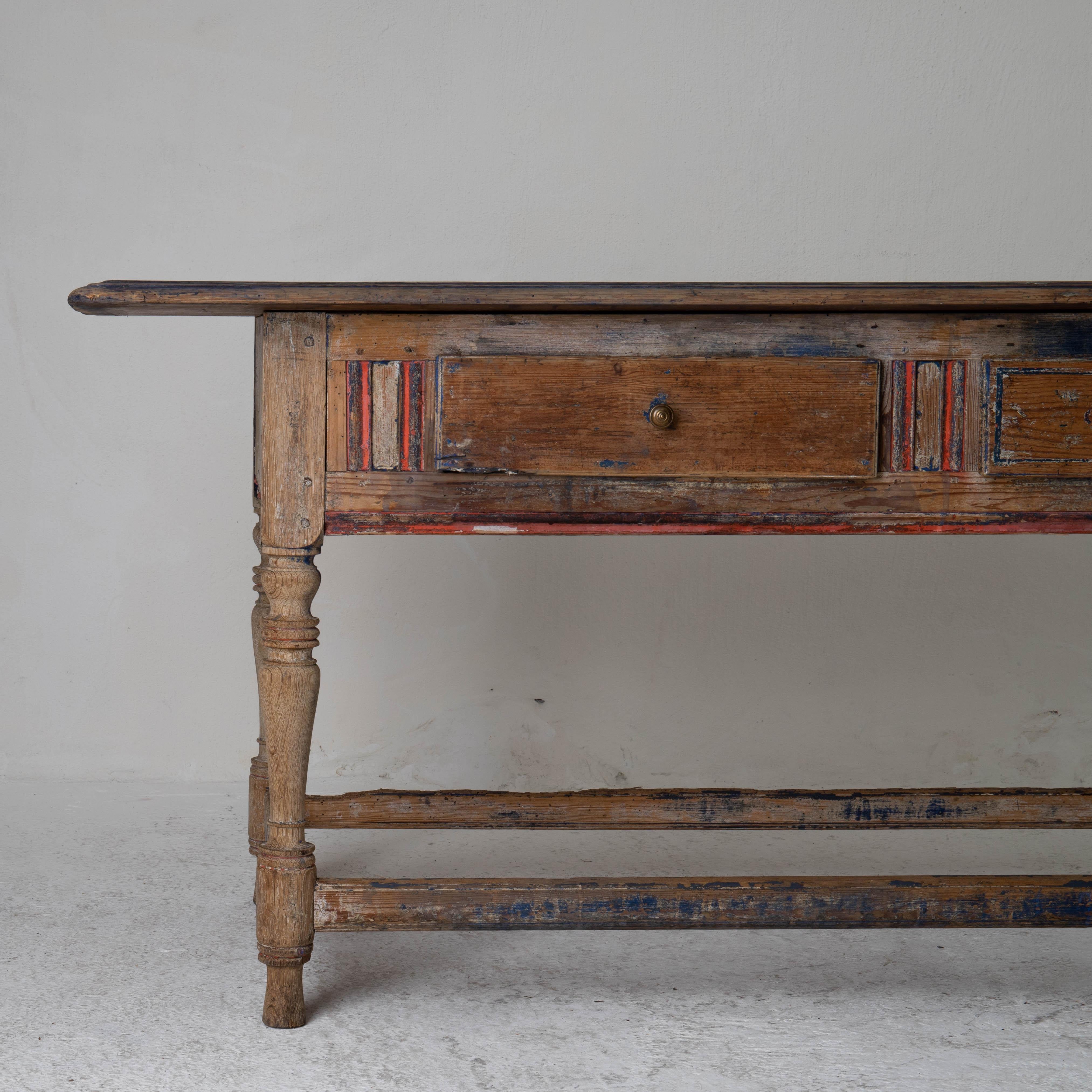 Table Swedish rustic 19th century blue red original paint wood Sweden. A table made during the 19th century in Sweden. Beautiful left overs from the original paint. 2 drawers in the frieze.