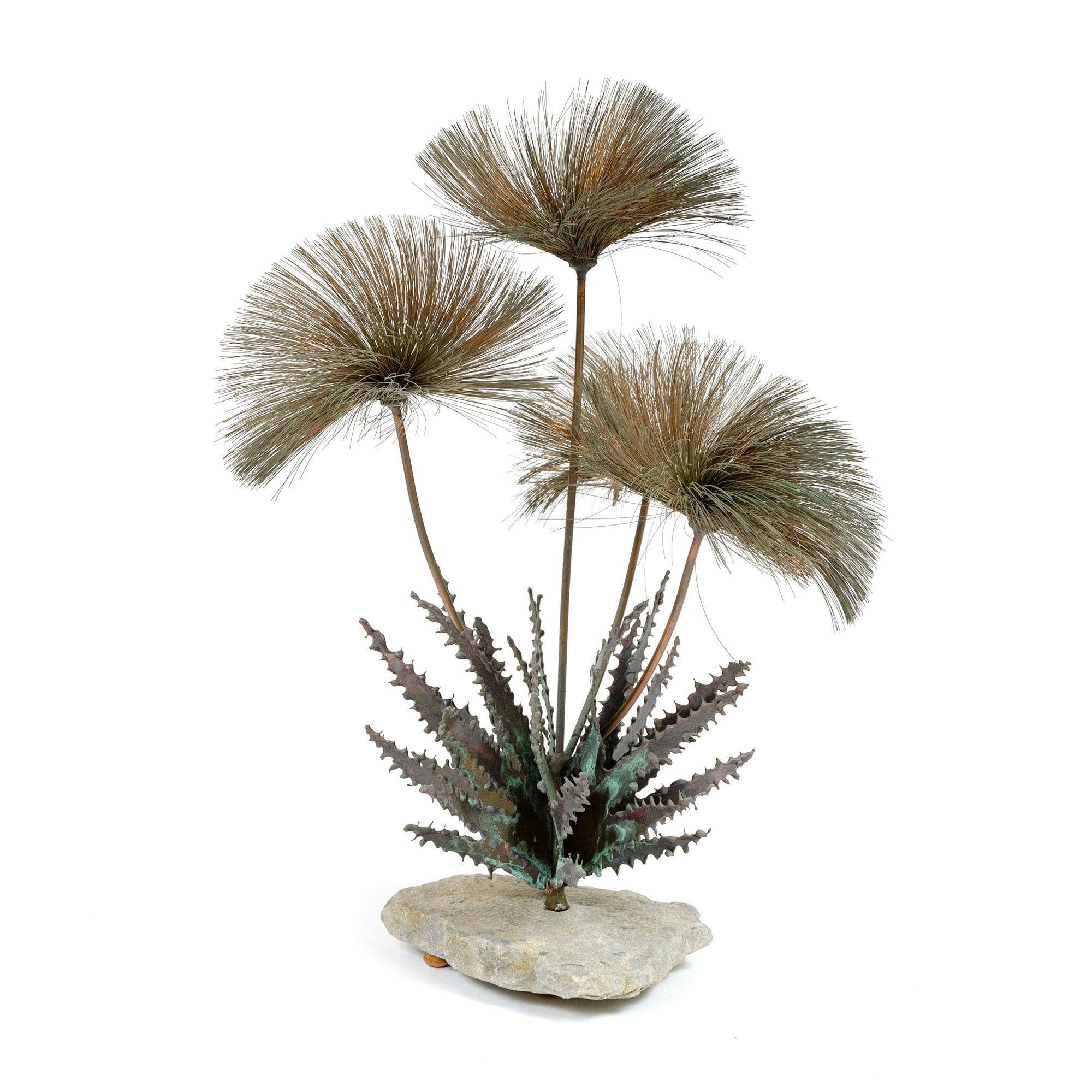 From Steck's 'Desert Flower' series, this table top sculpture exhibits, per an America House advertisement in Craft Horizons January/February 1965 (which illustrates this sculpture), â€œsizzle blooms of burnished copper on long-stemmed bronze and a