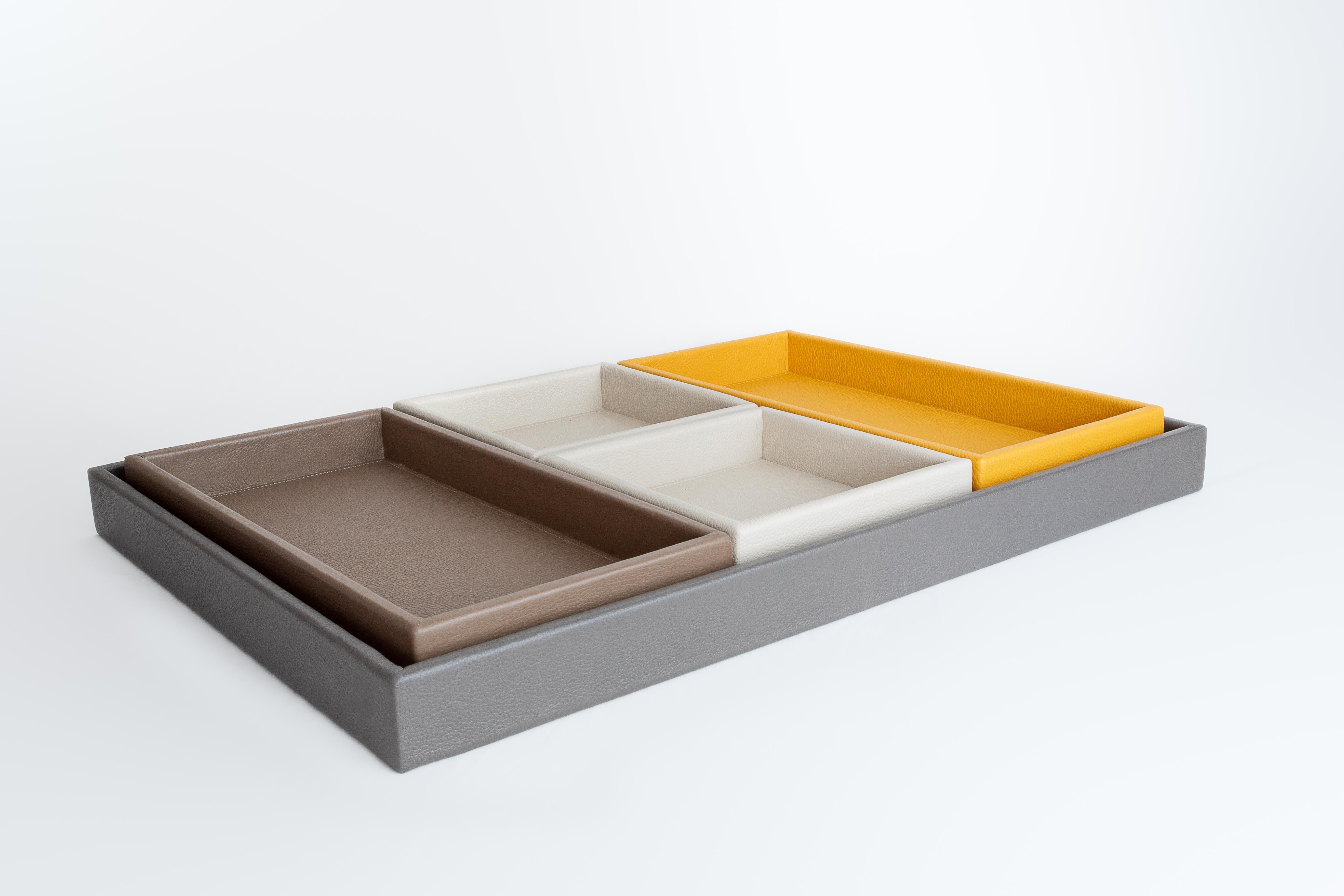 Table Tray Set - Set of 5 trays in different colors 

Include:
- 2 (two) Leather Tray, Small Square Tray Color: Vanilla 
Dimensions: 
Height: 1.58 in (4 cm)
Width: 6.89 in (17.5 cm)
Depth: 6.89 in (17.5 cm)

- 1 (one) Leather Tray, Medium A