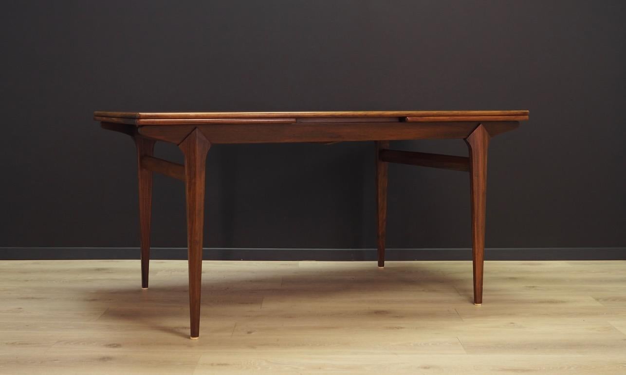 Phenomenal table form the 1960s-1970s. Scandinavian design, Minimalist form. Tabletop finished with rosewood veneer. Construction made of solid rosewood. Table can be unfolded. Maintained in good condition (minor bruises and scratches), directly for