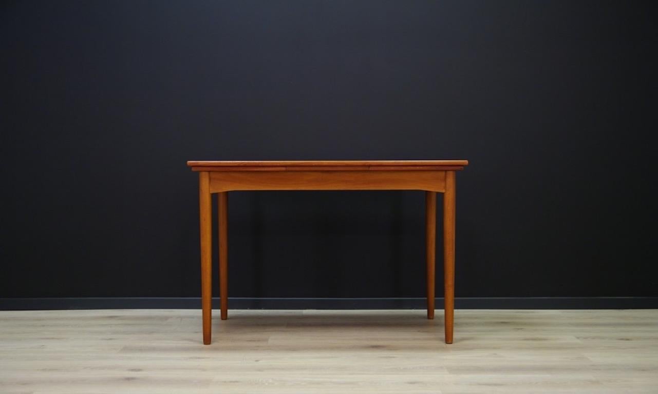Original table made of teak veneer from the 1960s minimalistic Danish form, frame and countertop veneered with teak, legs made of solid teak. The table has two pull-out inserts. Preserved in good condition (visible scratches and abrasions on the