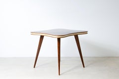 Table with cloverleaf top in veneered walnut and parchment profile