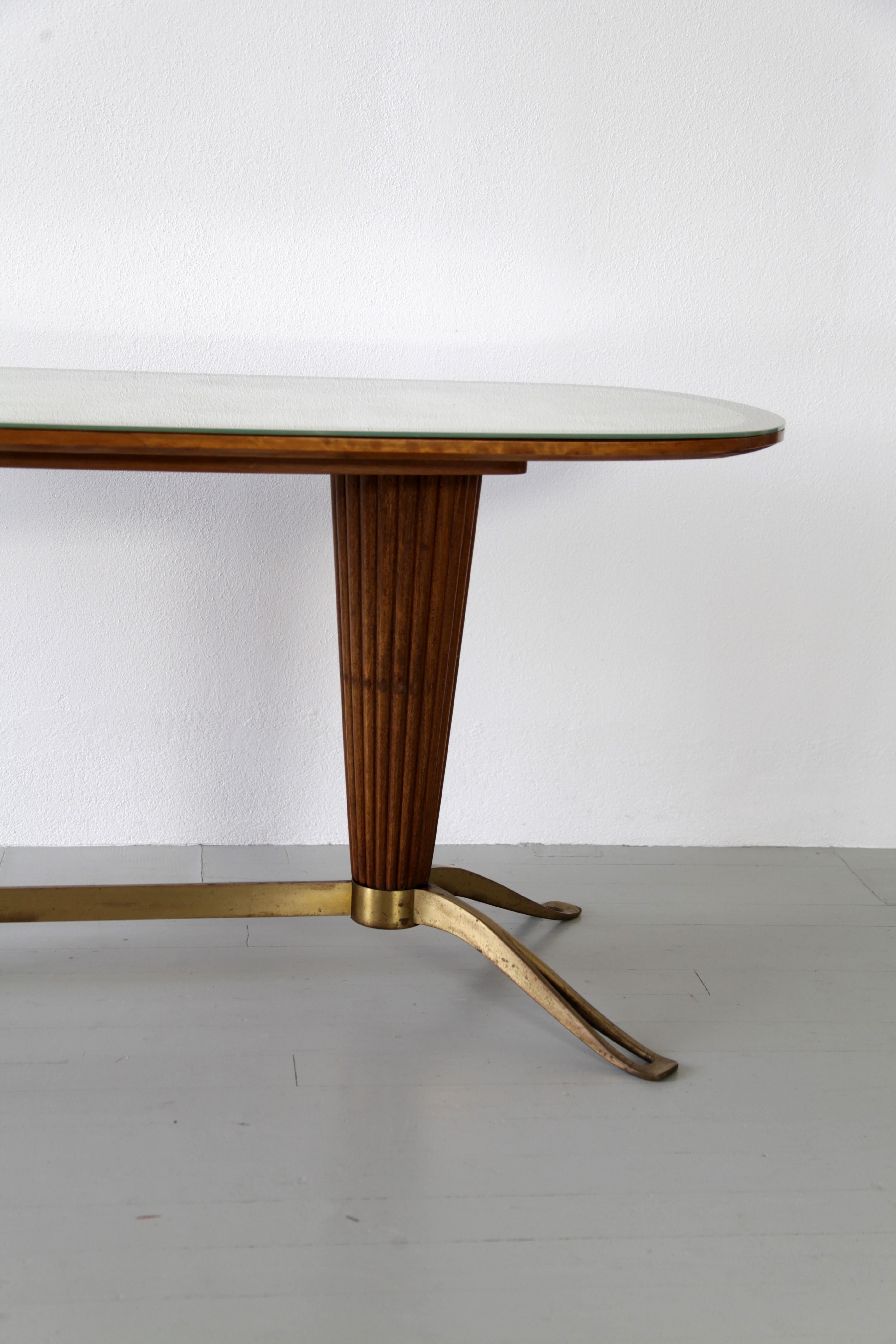 Table with tapered column base within the frame brass, walnut and glass are used. Interestingly this design features a zonal separation of materials, on brass follows wood and on wood follows glass.

Feel free to contact us for more detailed