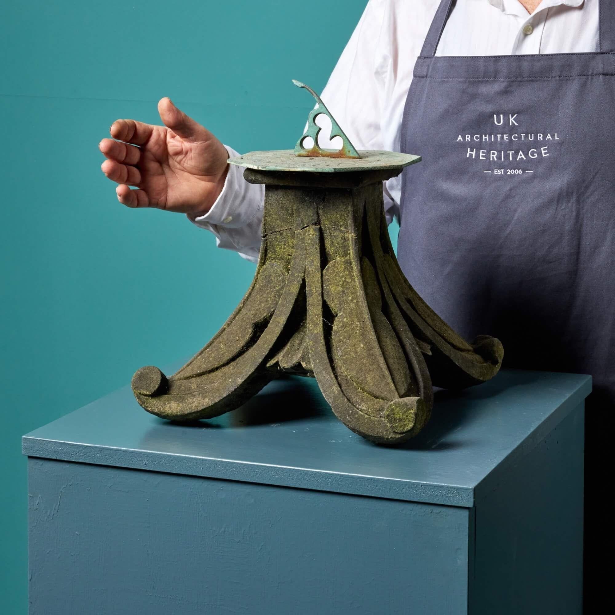 Dating from the early 20th century, this small tabletop antique garden sundial sees a stylistically carved York stone base below a later horizontal bronze sundial. It is a beautiful garden ornament for a small outdoor setting or a quiet sunlit
