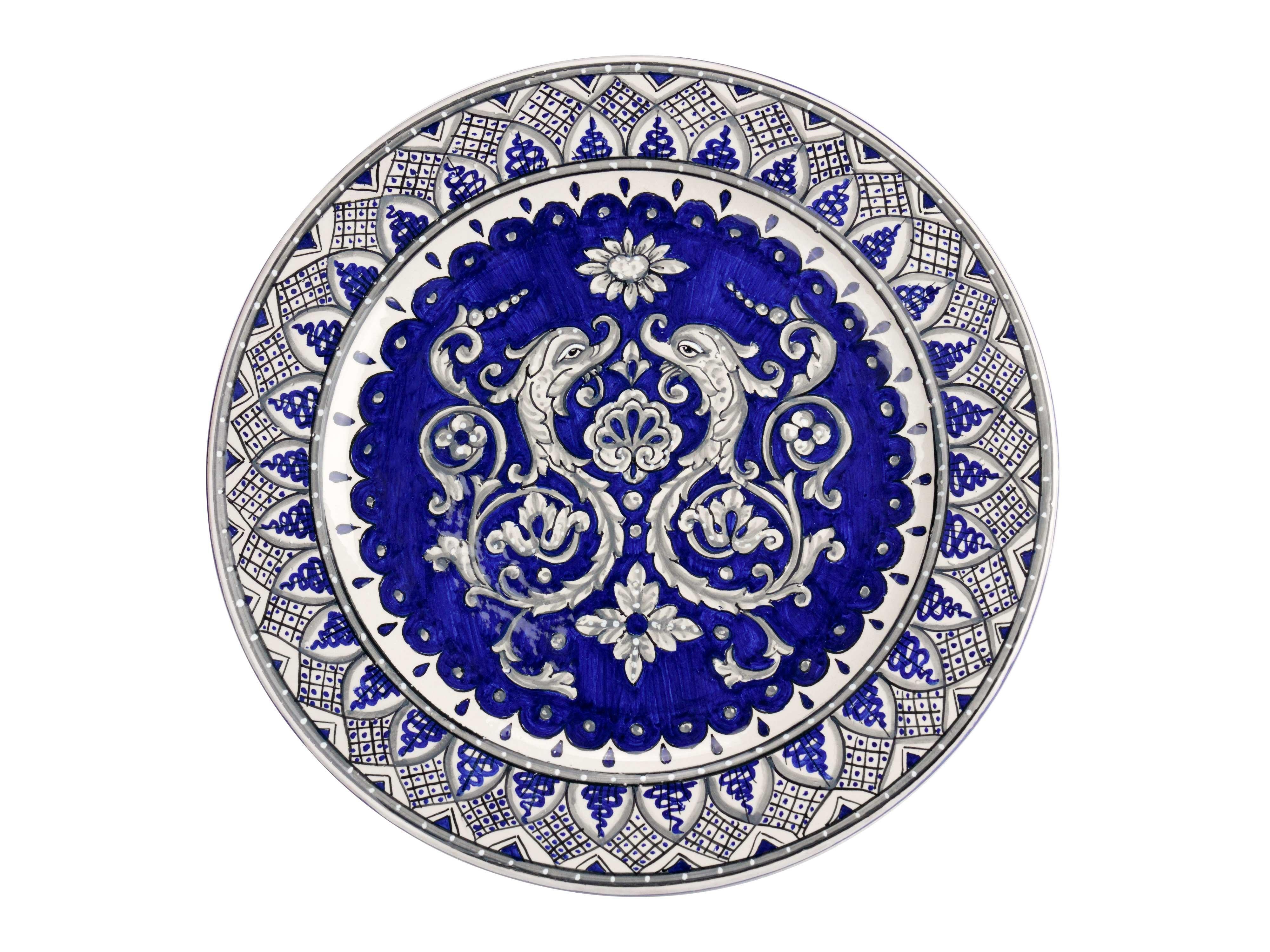 Exclusive ceramic set for the decoration of the table in blue and white, consisting of a bowl centerpiece with snake-shaped handles and four tablemats painted with the technique of majolica. The centerpiece cup has a maximum width of 42 cm, the