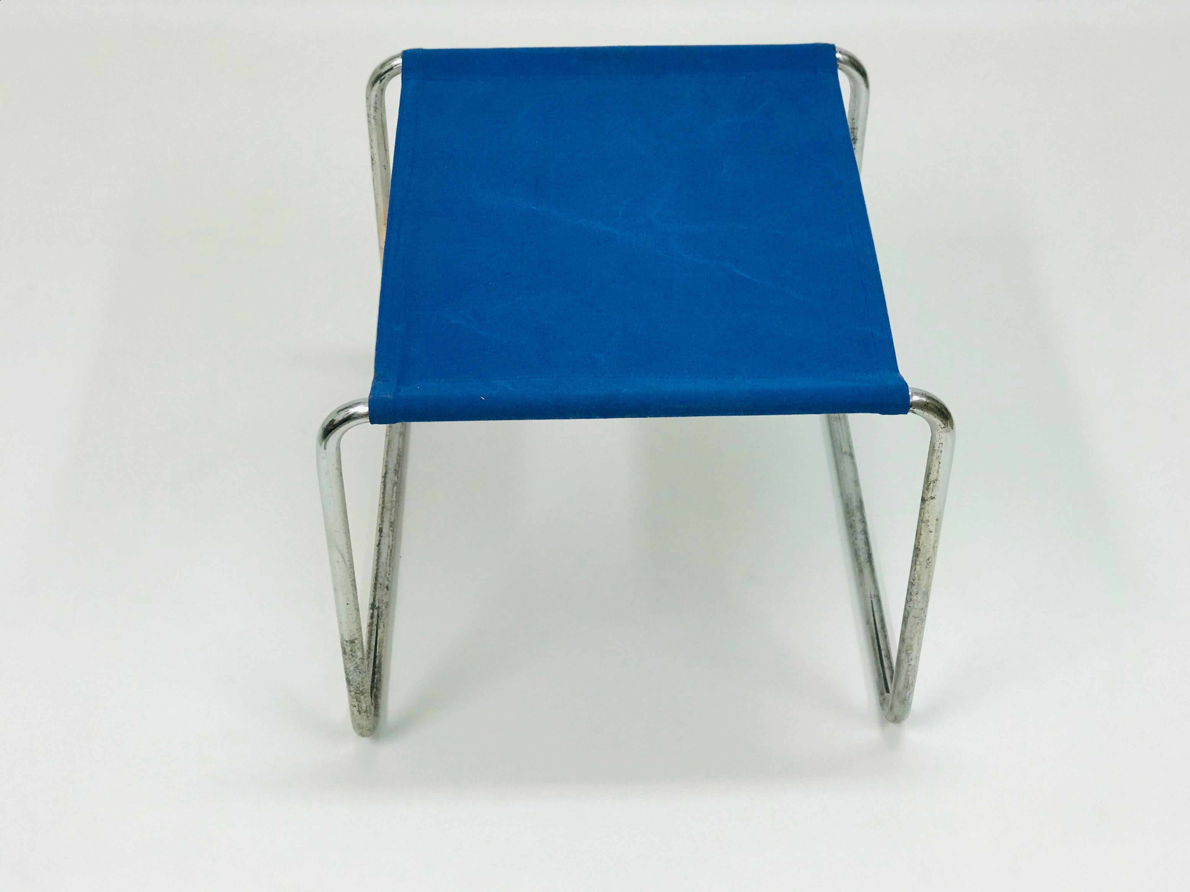 The tabouret by Marcel Breuer is in original condition. The fabric seat is attached with steel chrome-plated construction.