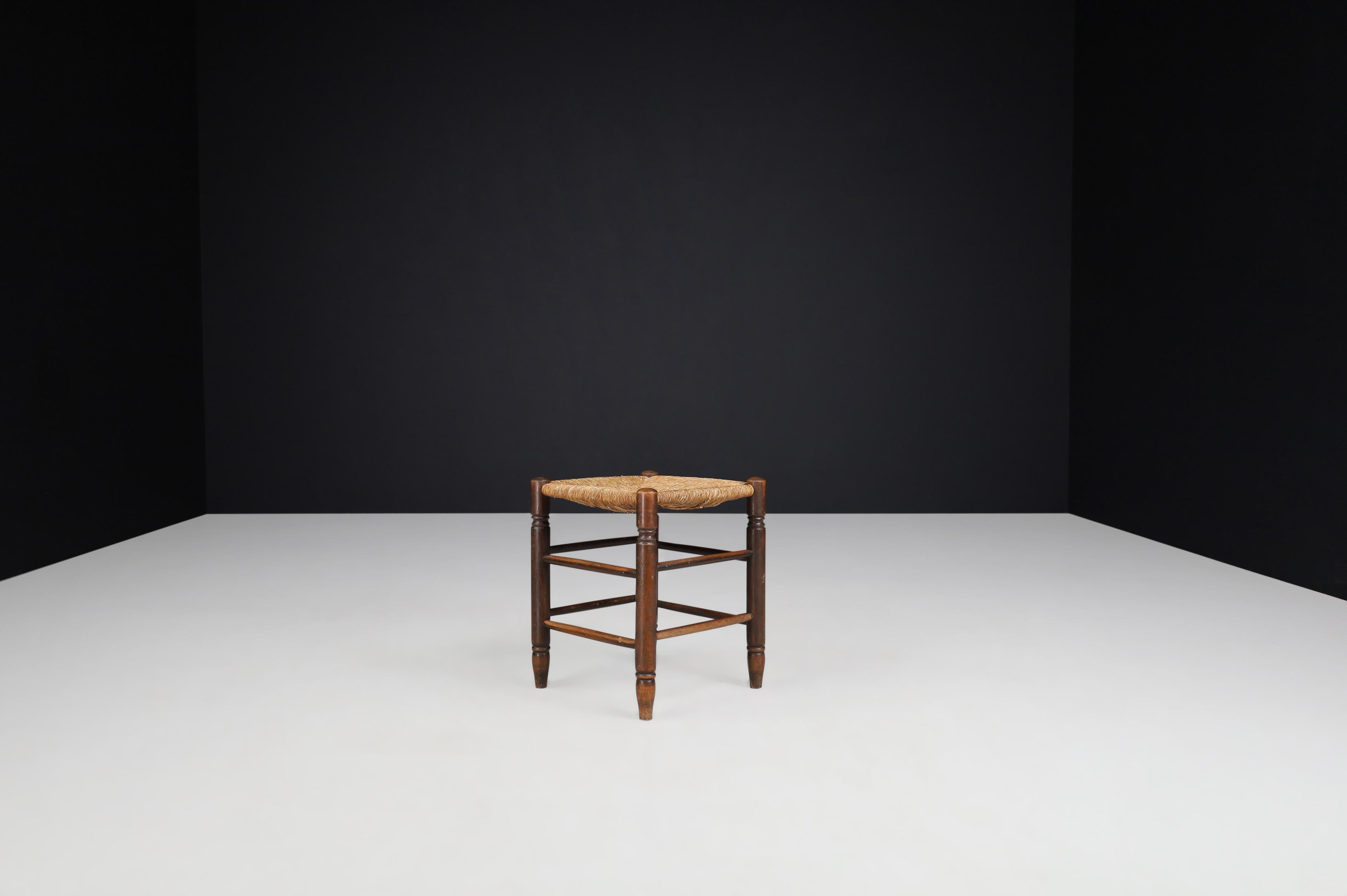 Tabouret in the style of Charlotte Perriand, France, 1950s.

This solid oak Tabouret shows a lovely natural patina, is in excellent original condition, and has a great patina and natural wear to the wood and rush. This stool would be an