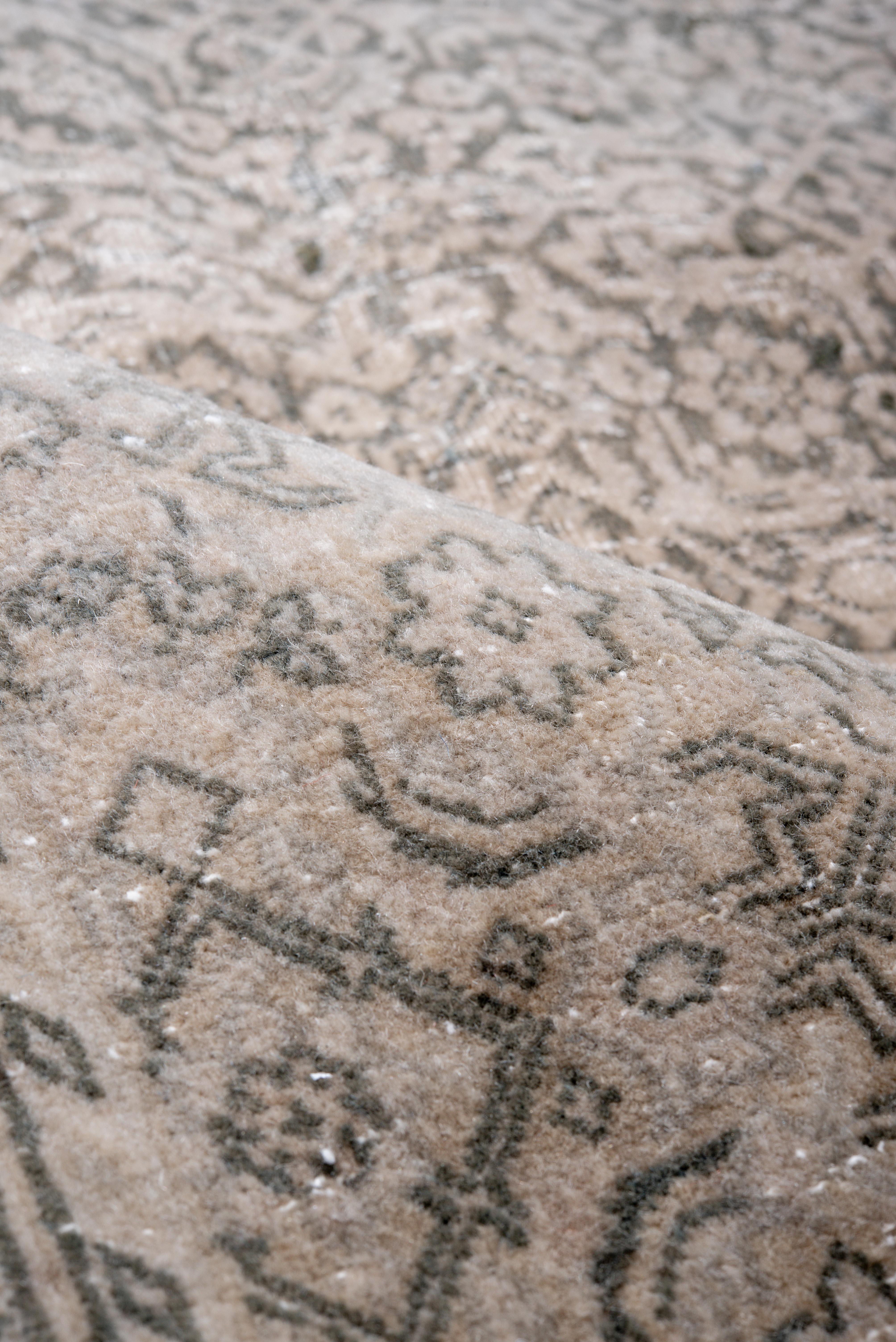 This finely woven Tabriz Persian rug features a sophisticated central medallion surrounded by intricate floral patterns, embodying classic elegance and high craftsmanship. Its subdued palette of earthy and muted tones makes it a versatile addition