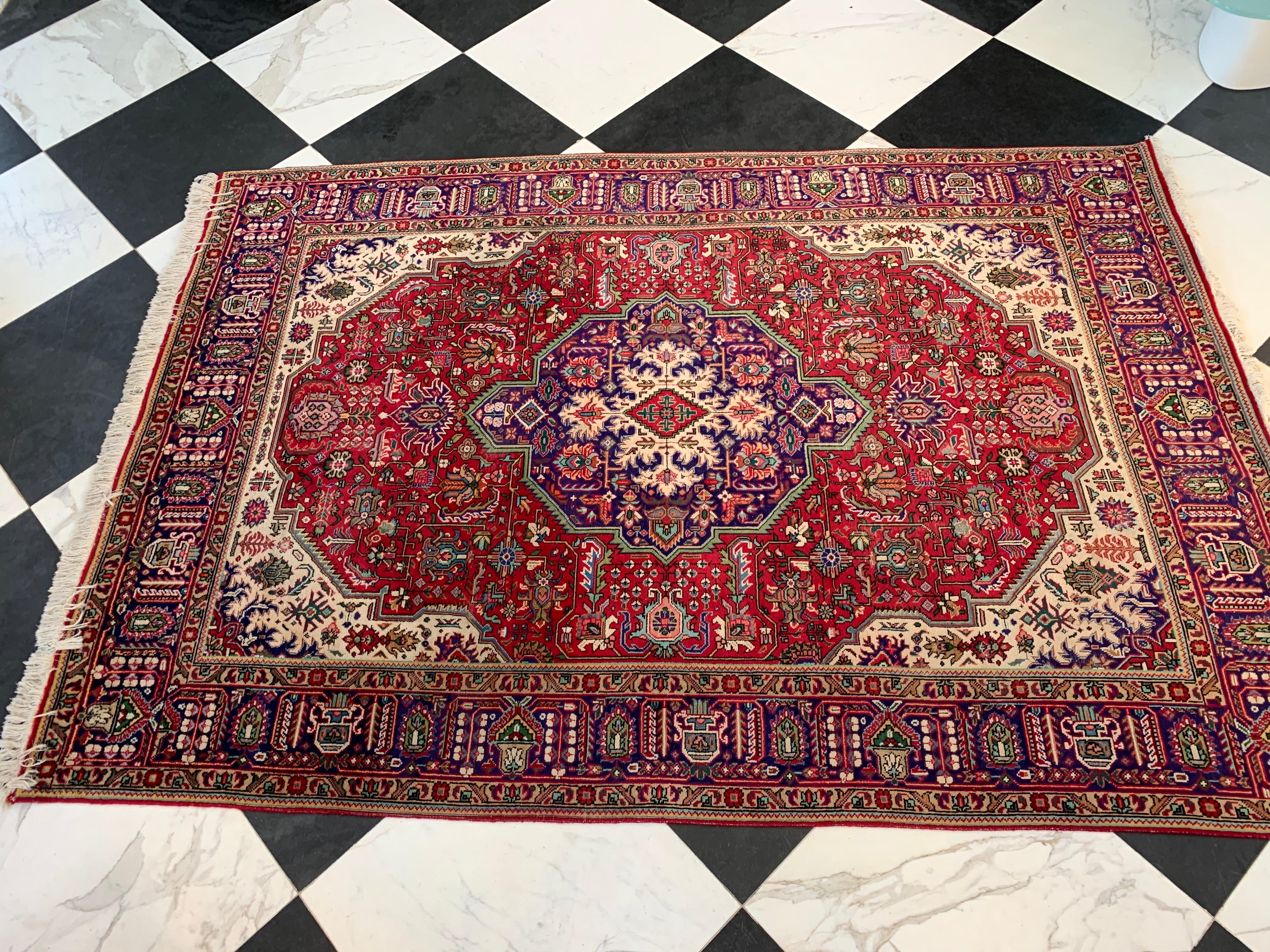 This Tabriz rug has it’s original manufacturing label still attached. A beautiful Center Medallion in the traditional weaving style is in the center. The colors range from red, ivory, blues to deep purples.
 