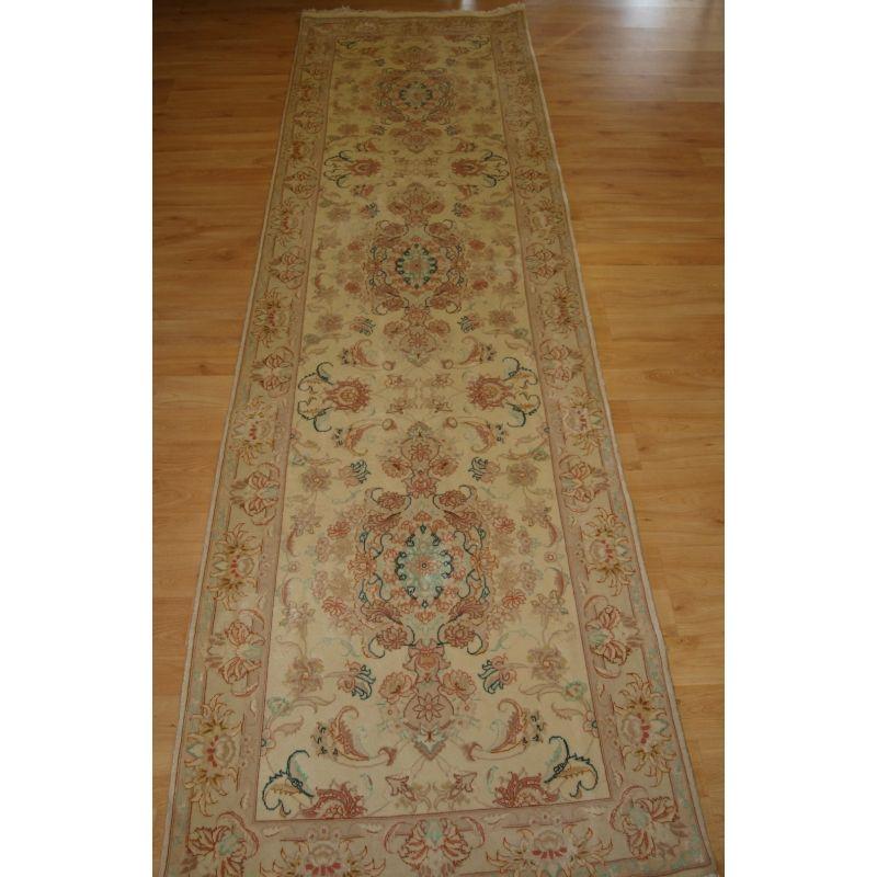 Very fine hand knotted Tabriz runner in lambs wool and silk.

The runner is about 5-10 years old but unused.

Very soft ivory ground with a floral design in soft pastel shades.

Excellent condition with no wear and full pile.

Ideal runner for