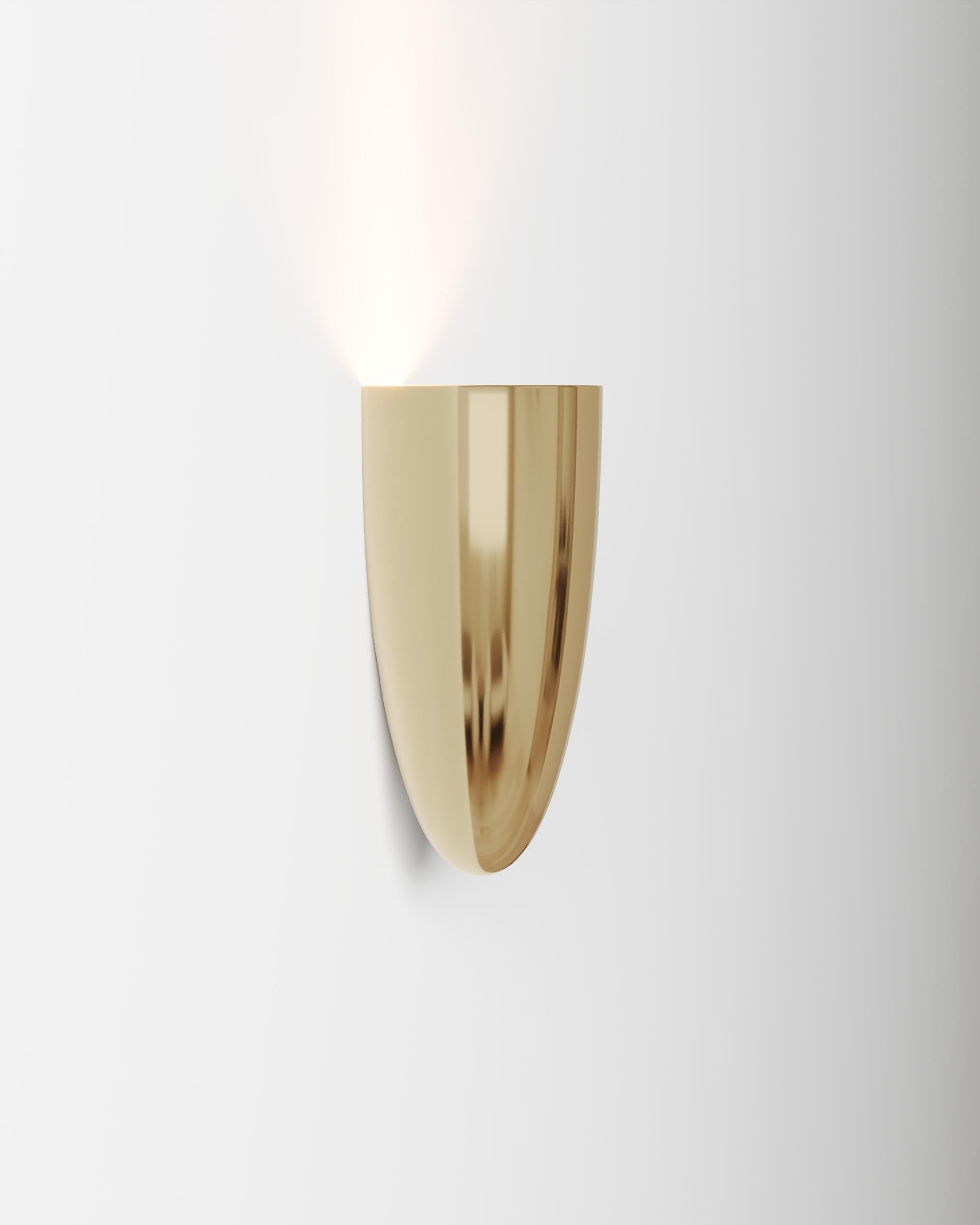 Tabu P Wall Lamp by Studio Orth
Dimensions: W 10 x D 10 x H 21 cm
Materials: Cast metal.
Finishes: Polished Cast Brass or Polished Cast Aluminum

Also available in Polished Cast Brass or Polished Cast Aluminum.

All our lamps can be wired according