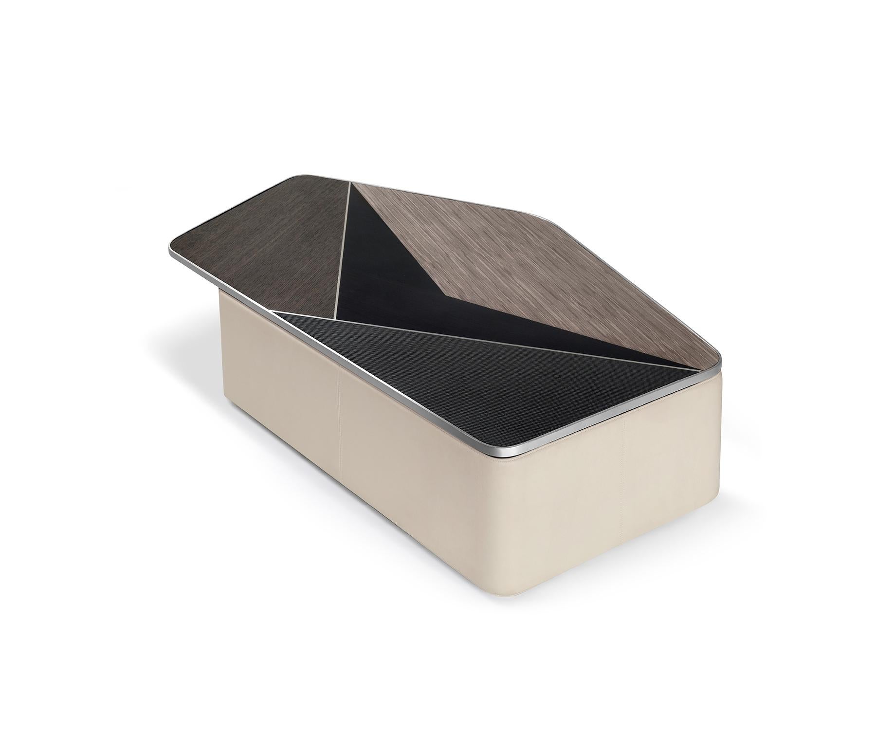 The Tabula large stands as a sculptural statement—an organic form composed with bold material contrasts.

Crafted using traditional techniques, it features a textured veneer and carbon fibre high-gloss finish tabletop, leather wrapping, and polished