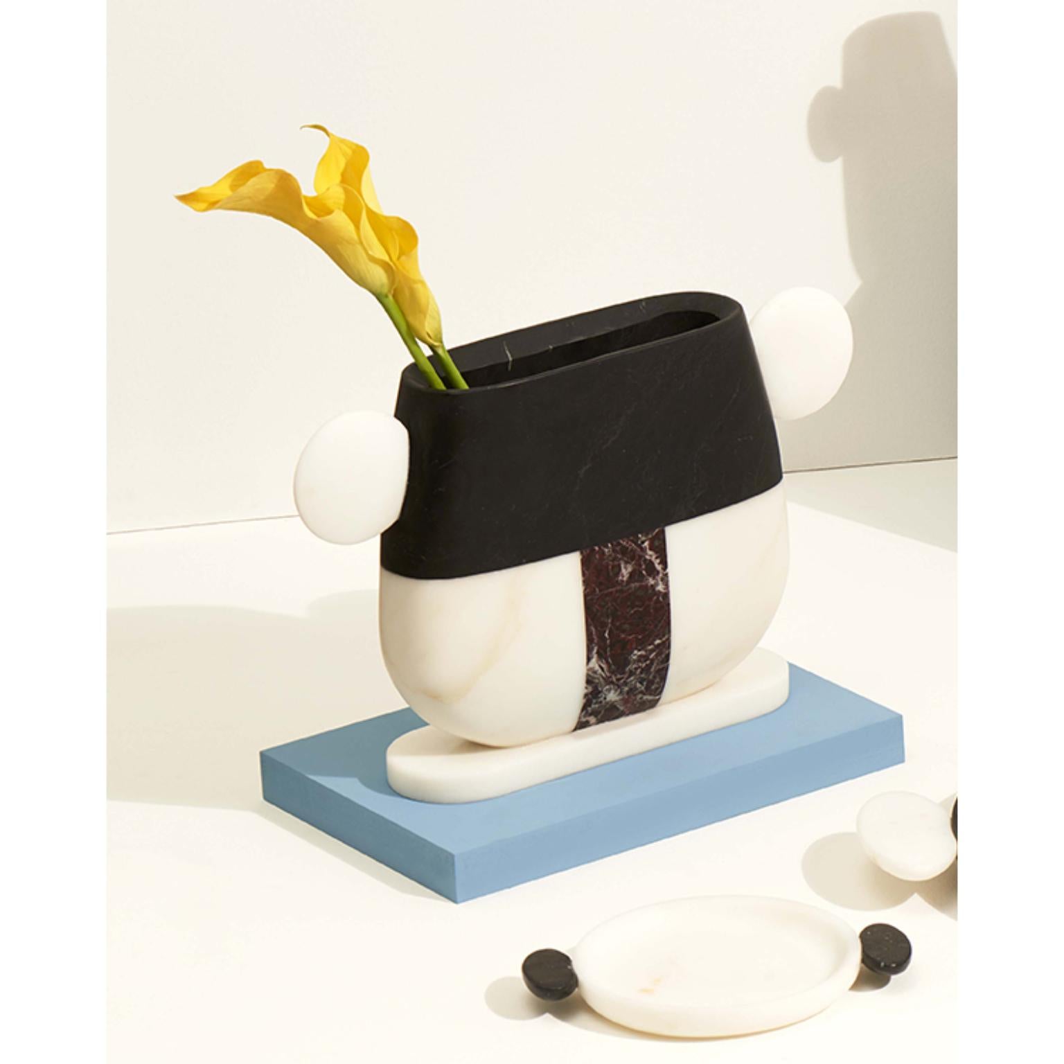Taca marble vase by Matteo Cibic
Dimensions: 38.2 x 7.3 x 23.4 cm
Materials: Nero Marquinia, Bianco Michelangelo

Vases made of various marbles cannot guarantee watertightness, better not use for cut flowers unless with the use vials for each flower