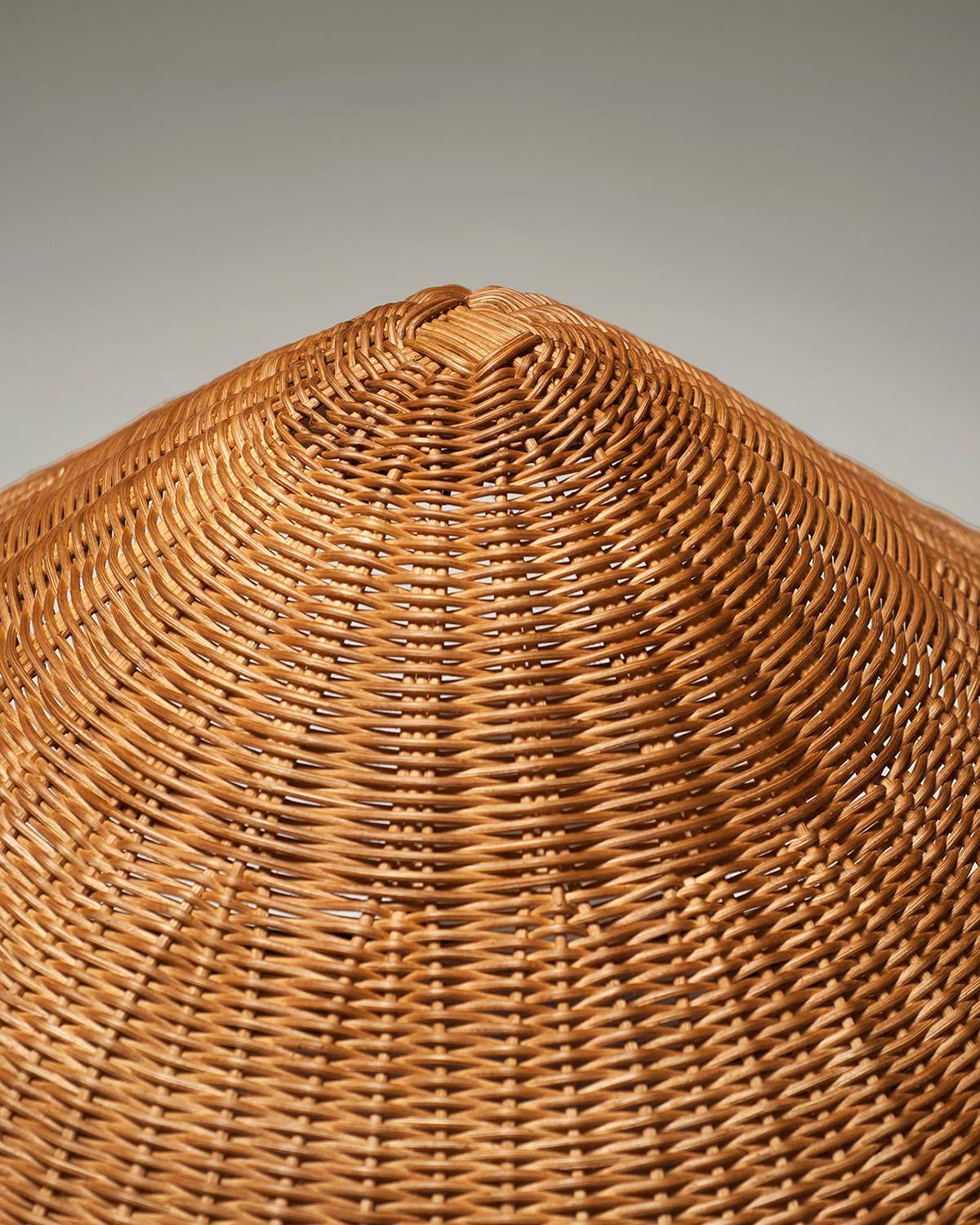Hand-woven natural rattan, cement and bush-hammered limestone meet in this item, in a playful mix. Unusual superimpositions of sources give life to a lamp in which different materials, united by the same iconographic purity, write a new chapter, in