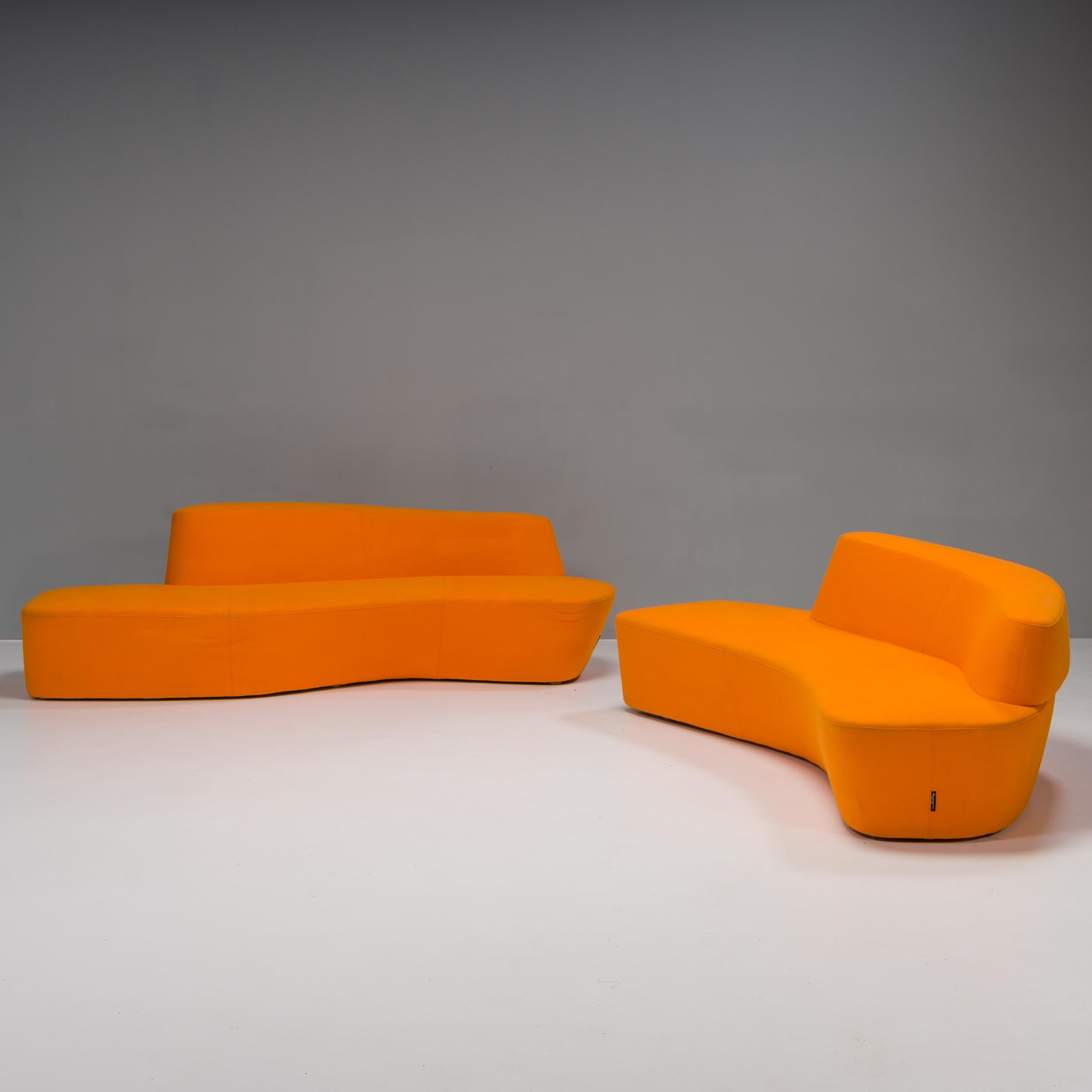 Designed by Pearson Lloyd for Tacchini, the Polar seating collection was inspired by the icebergs of the Arctic.

This set comprises two sofas, one larger and one smaller, both upholstered in vibrant orange fabric, which can be combined to create
