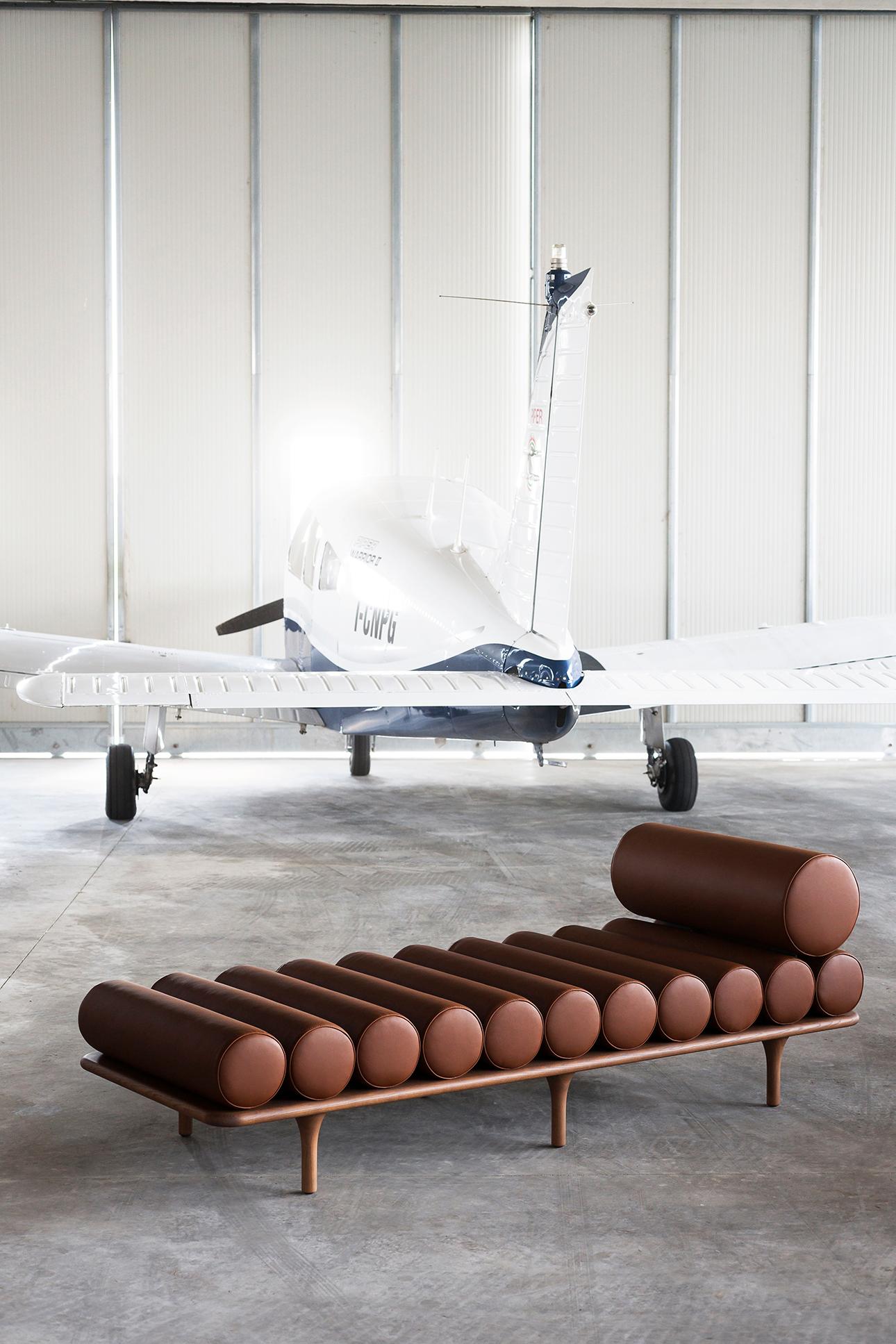 Tacchini Five to Nine Daybed with headrest in aniline leather by Studiopepe. The Five to Nine daybed draws inspiration from 1900s scenic designs that portrayed a place for creative escape – a space as physical as it was mental – the studios of the