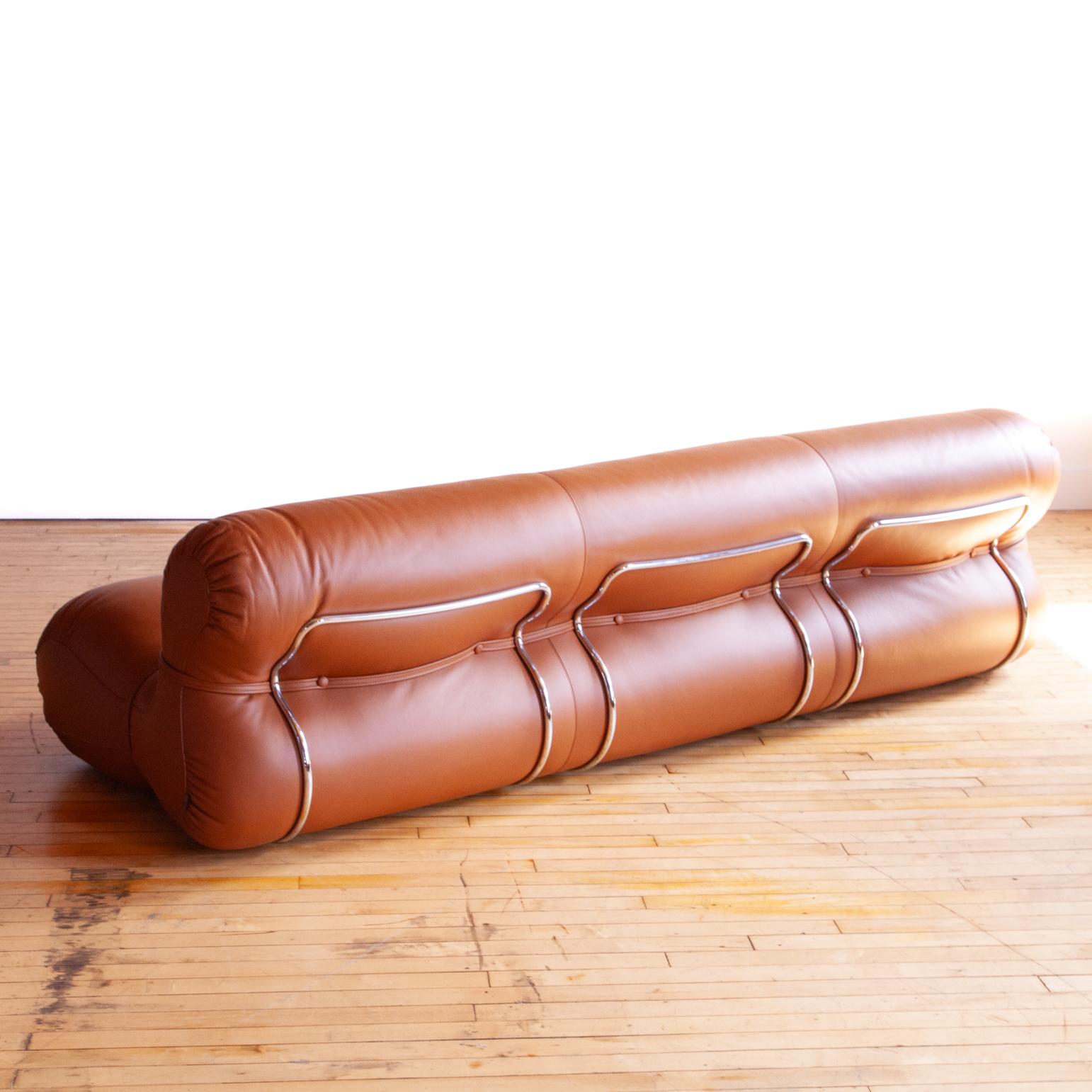 Originally designed in 1970 by Gastone Rinald. This contemporary production is licensed to Tacchini Italy. 

Upholstered by Italian masters in thick premium cognac leather over multi-density polyurethane foam. Supported by a rounded chrome metal