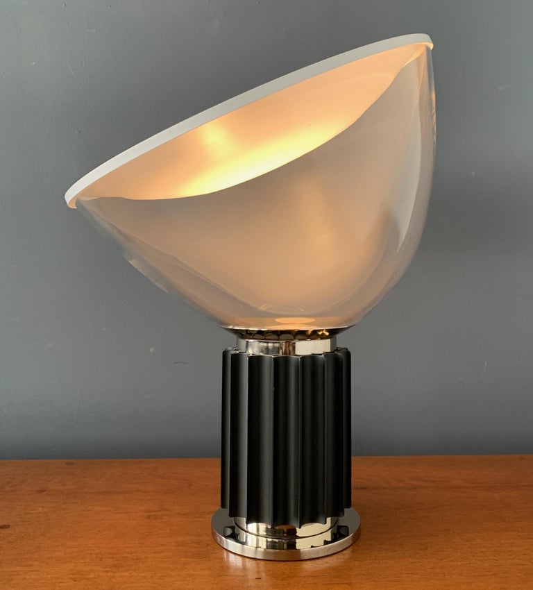 Taccia lamp by Pier Giacomo and Achille Castiglioni for Flos Italy. The lamp is in exceptional original condition. The blown glass shade can pivot upon the metal base fixture to create different lighting effects. From the 1970s-1980s production.
  