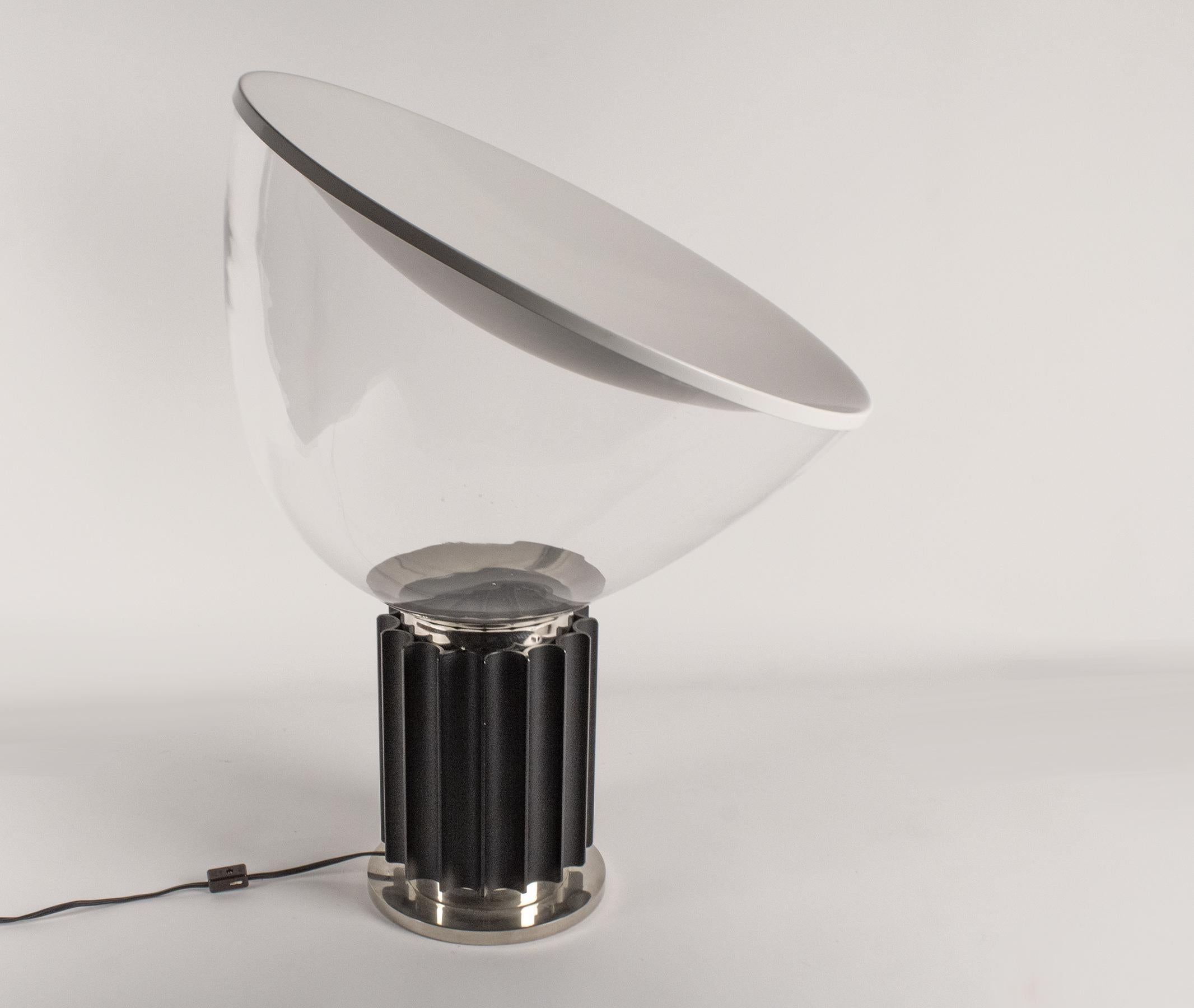 Vintage adjustable Taccia table lamp. This piece is signed with the Flos label. 
A gorgeous mood lamp that reflects the light off of the convex metal topper through the blown glass shade. 
A true Italian design icon and light sculpture. 
 