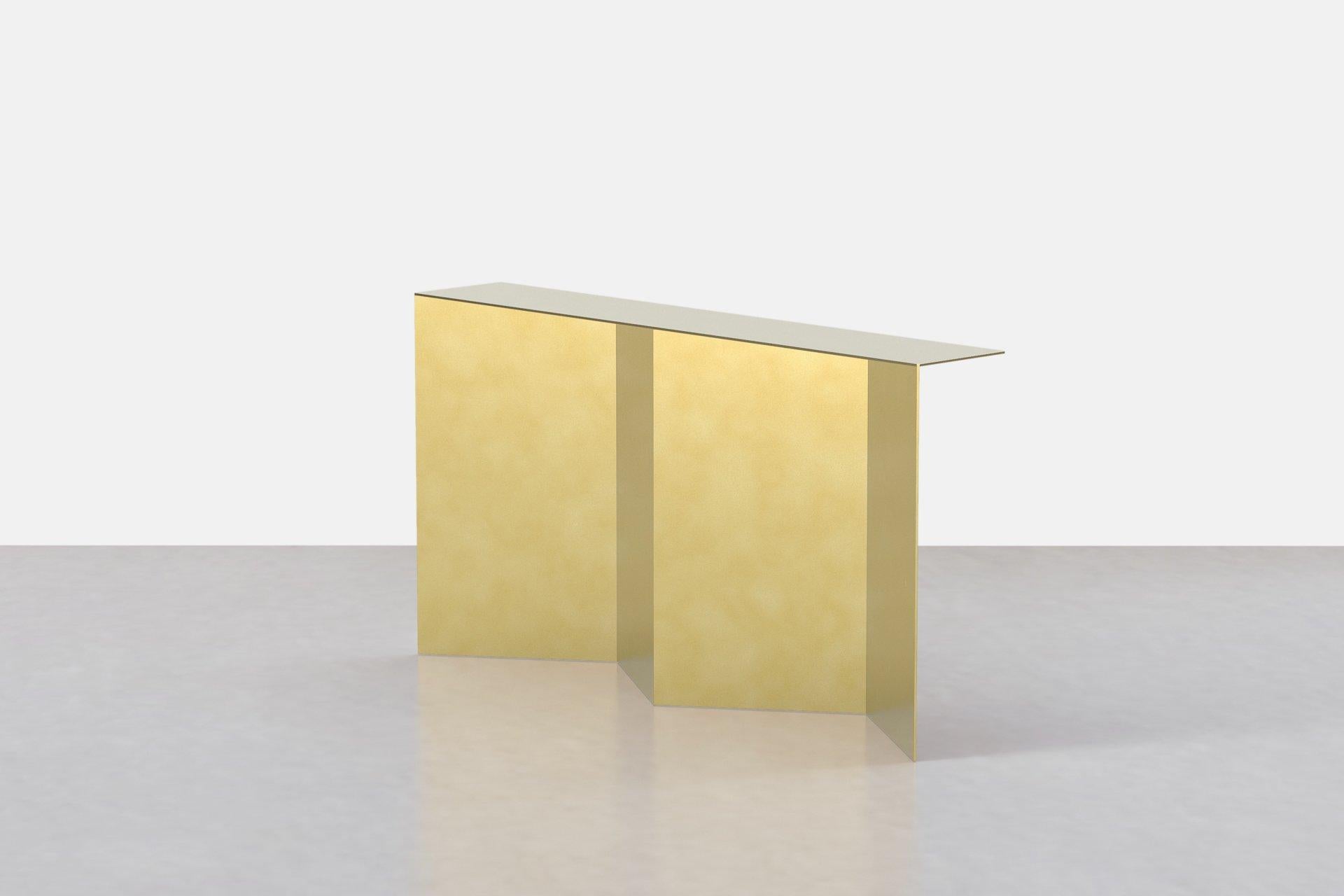 The tack console in brass explores the nuances of minimal planes, angles, and intersections. Crafted from solid brass and seamlessly welded together, the Tack is hand made to order in our studio. The brass is hand finished in custom patinas and sits