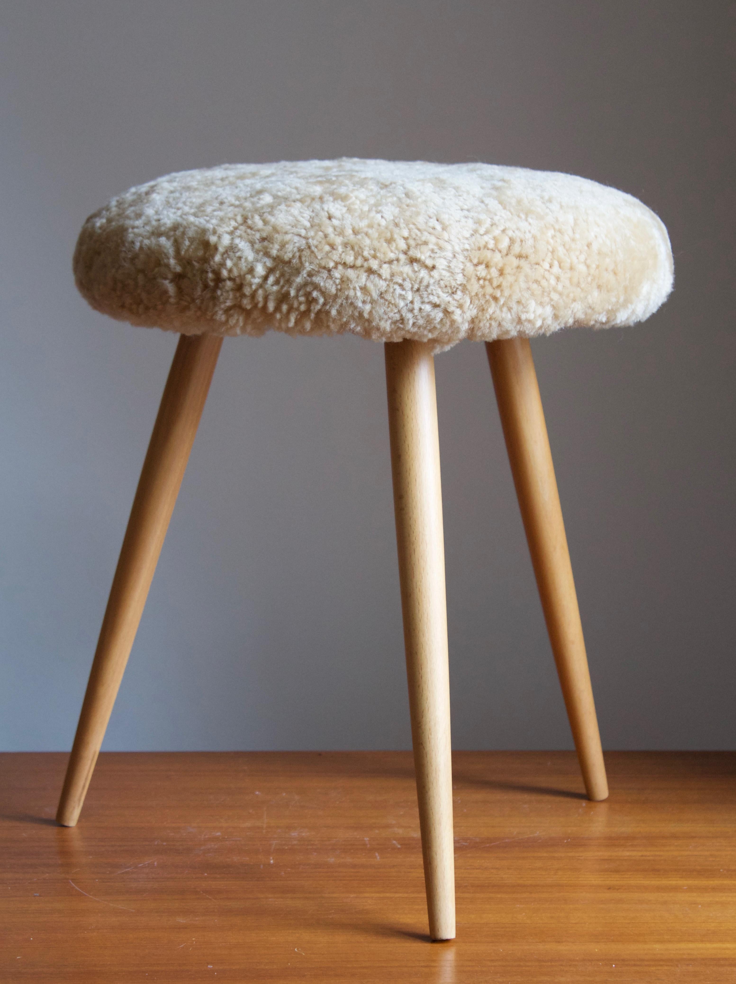 A stool in wood, overstuffed seat reupholstered in brand new sheepskin upholstery. With production label.

Other designers of the period include Finn Juhl, Hans Wegner, Isamu Noguchi, Charlotte Perriand.