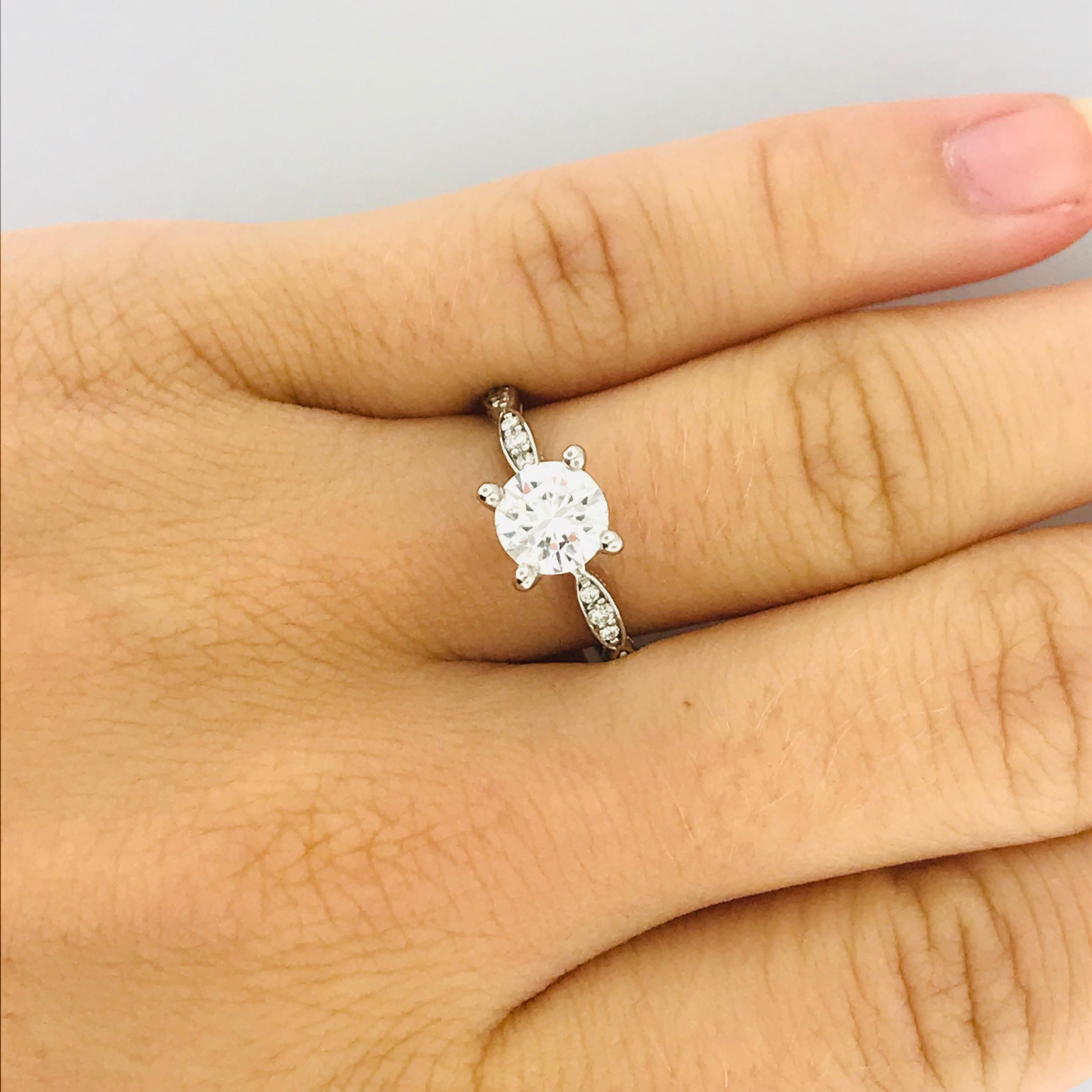 TACORI 18K WHITE GOLD ENGAGEMENT RING! This never before worn, new Tacori original engagement ring is stunning! The band is a unique piece of art itself. With a scalloped design that goes half way around the band that has been paved with diamonds.