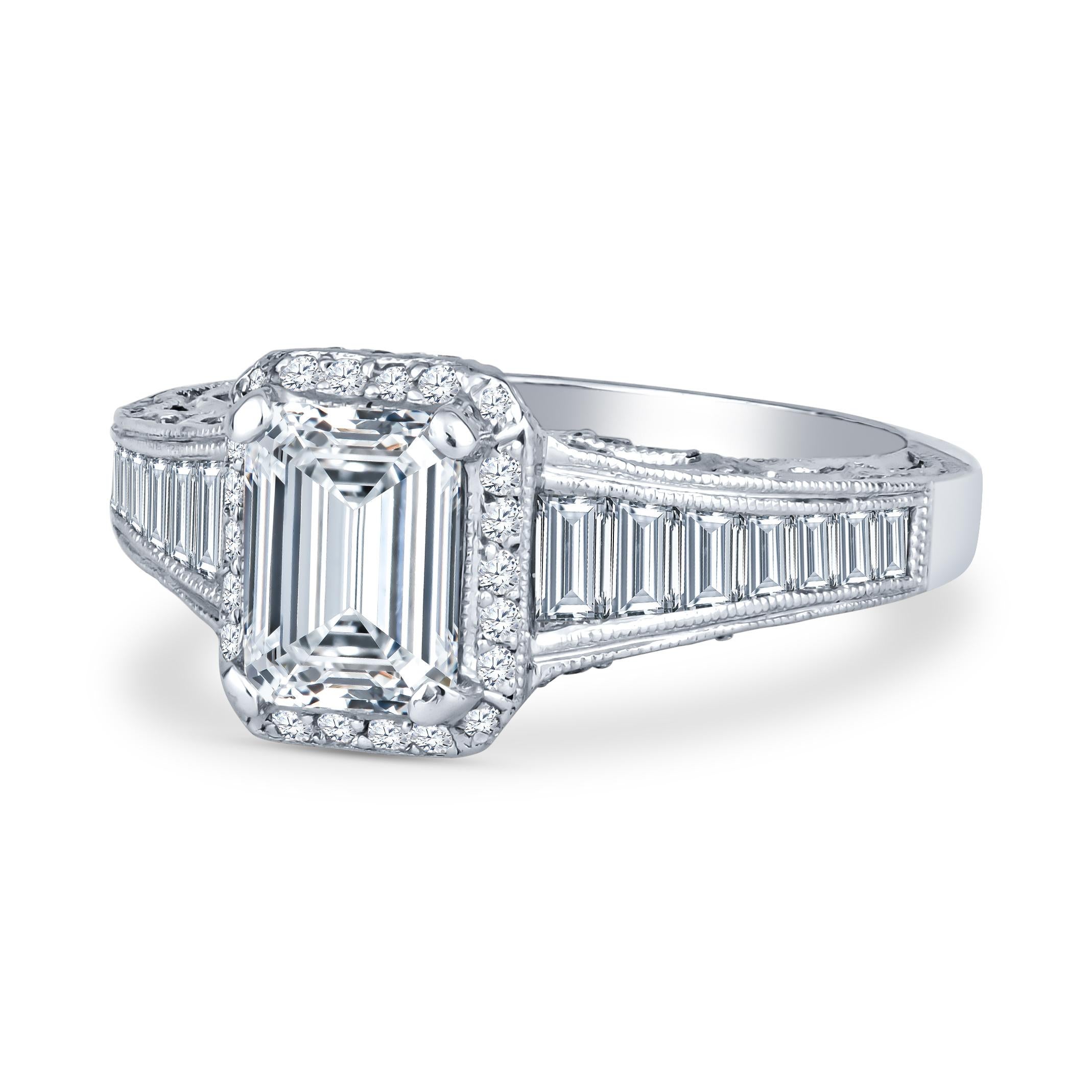 This stunning Tacori piece features a 1.01ct emerald cut diamond centerstone (I SI2, GIA Report #5202042286), accented by 1.35ct total weight in baguette and round diamond cut side diamonds. The ring itself is a platinum halo engagement ring. This