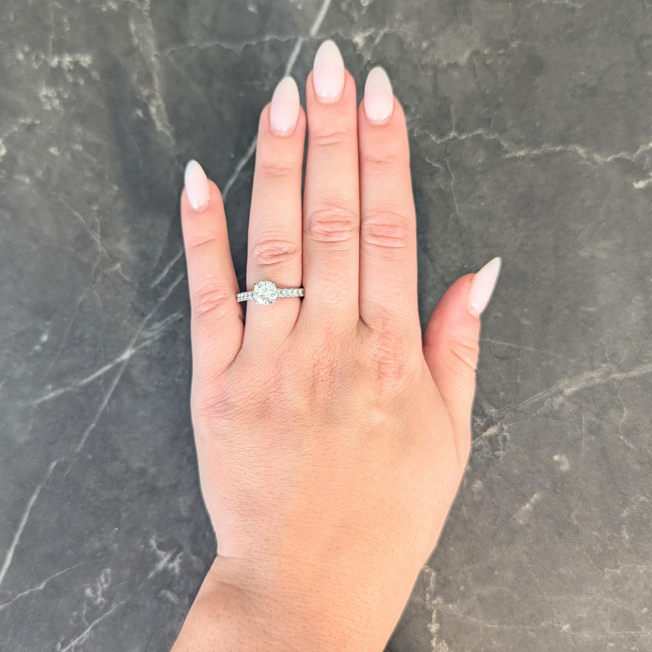 Centering a round brilliant cut diamond weighing 1.21 carat - H color with VVS2 clarity
Set in a stylized foliate head and flanked by cathedral shoulders
Accented by round brilliant cut diamonds pavé set throughout
Weighing approximately 0.50 carat