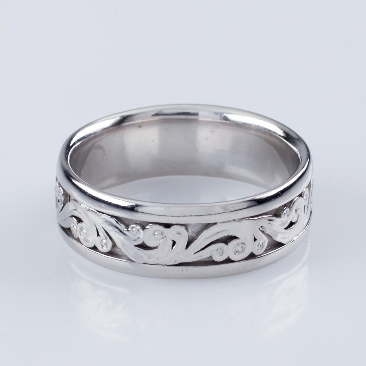 Gorgeous White Gold Wedding Band by Tacori
Features Floral Scroll Designs and Delicate Milgrain
Approximately 6.5 mm Wide
Size 11
Total Mass = 12.5 grams
Model #HT2392