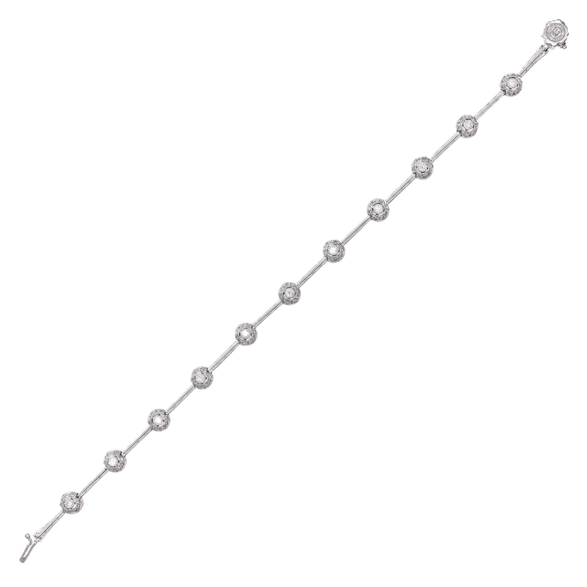 Tacori diamond bracelet. 11 round cut diamonds with round diamond halos set in platinum. Classic Tacori bead setting and cut out work. 7 inches in length. 

77 round diamonds, approx. total weight .90cts, G, VS
Platinum
Tested: Platinum
17.7