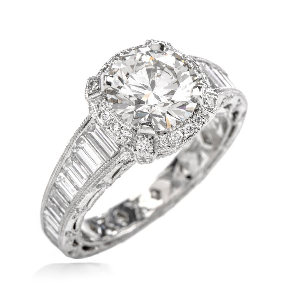 This bold diamond engagement ring is crafted in solid platinum, weighing 10.1 grams and measuring 10mm x 9mm high. Centered with one GIA certified round-brilliant diamond, weighing 2.05 carats, graded K color and SI1 clarity. Surrounded by a halo of