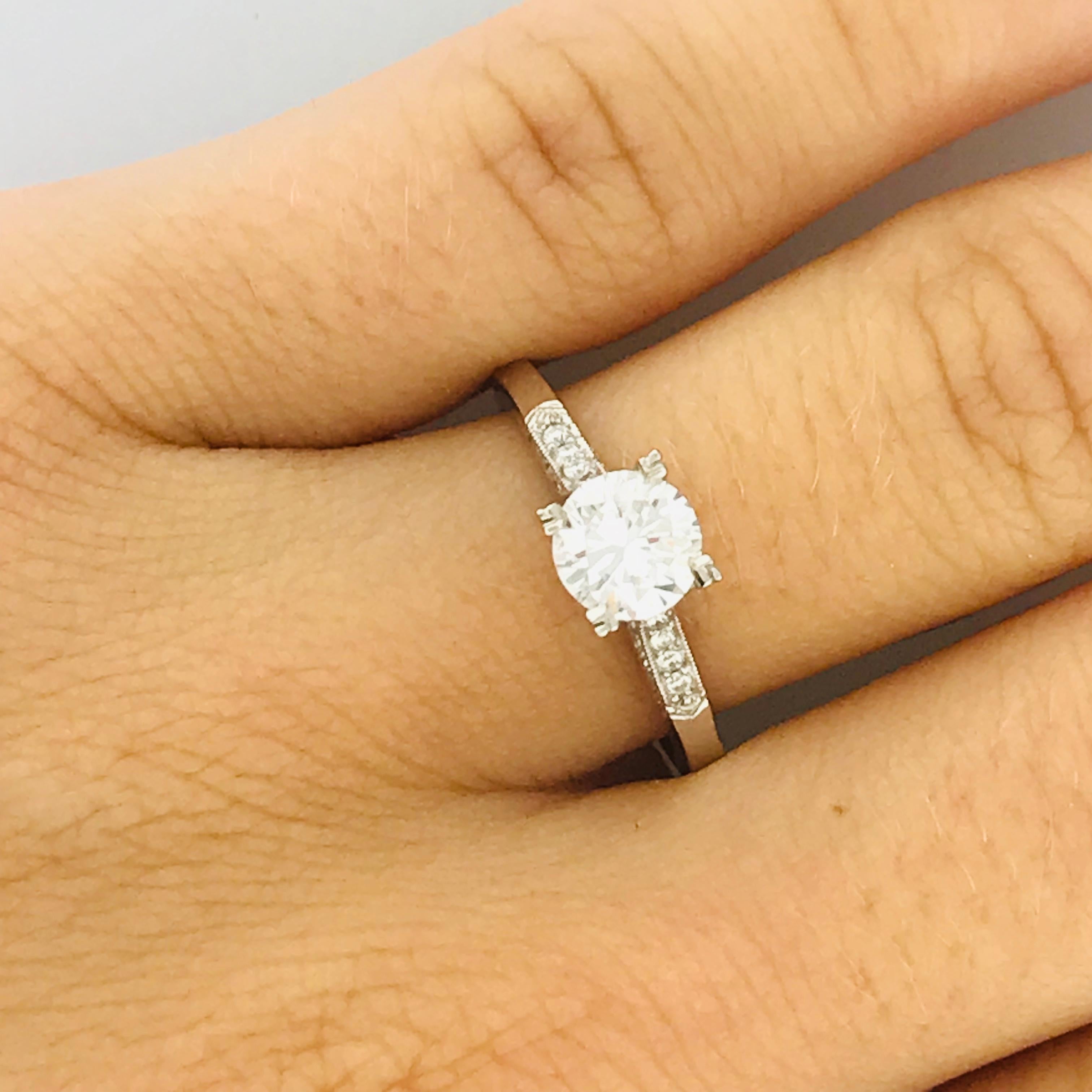 This Tacori original engagement ring is an 18k white gold mounting with round brilliant white diamonds. This Tacori piece has a very unique and fun feature, the prongs are shaped like an arrow or clover design! This is a special feature that is made