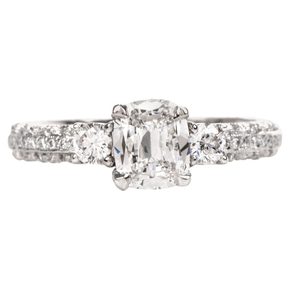 This highly decorative diamond engagement ring is crafted in solid platinum, weighing 5.7 grams and measuring 6mm x 6mm high. Showcasing a centered prong-set GIA lab reported cushion brilliant diamond, weighing 0.84 carats, graded F color and SI1