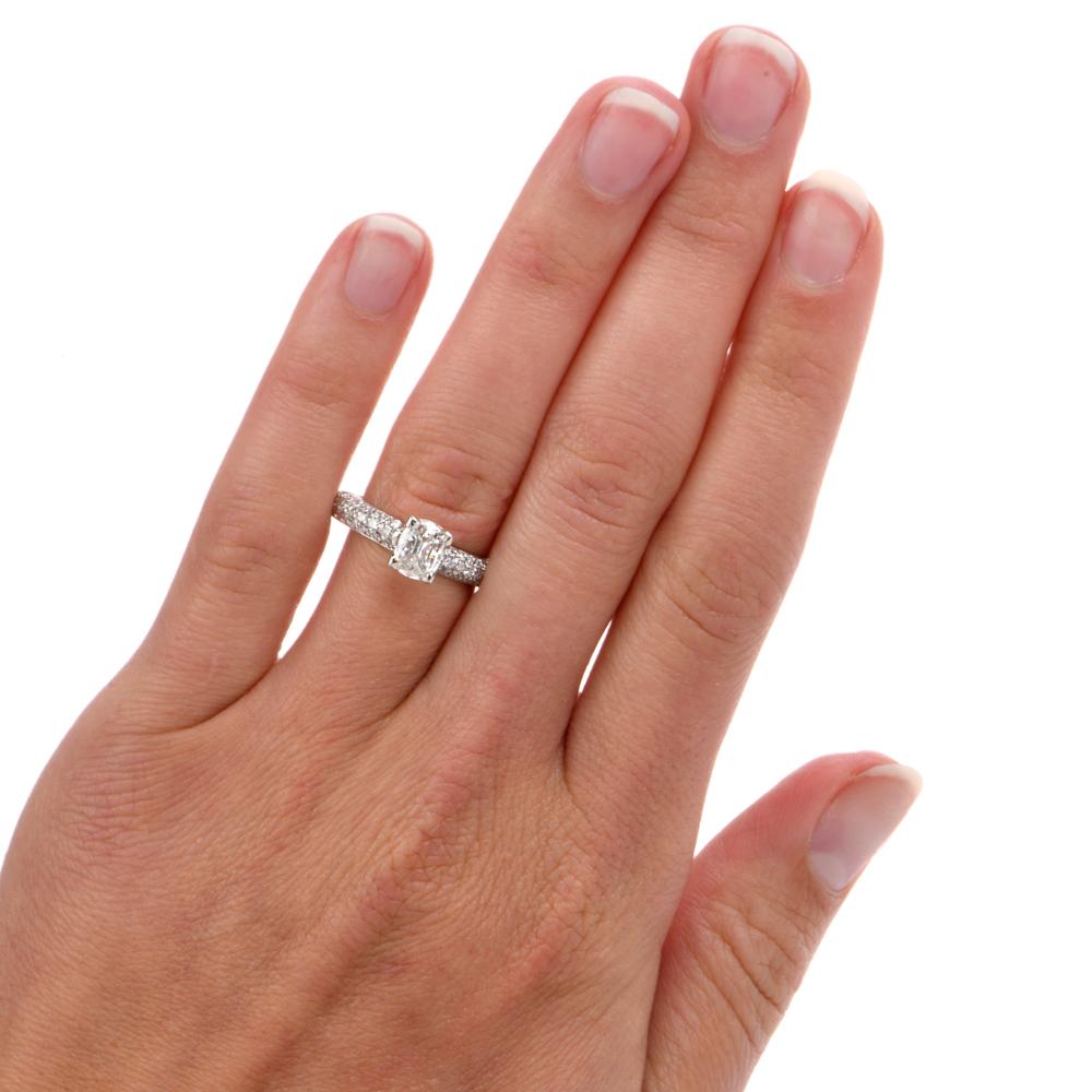 This glamorous shimmering diamond engagement ring is crafted in solid platinum, weighing 6 grams and measuring 7mm x 5mm high. Displaying a prominently prong-set GIA lab reported certified cushion-brilliant diamond, weighing 0.81 carats, graded H