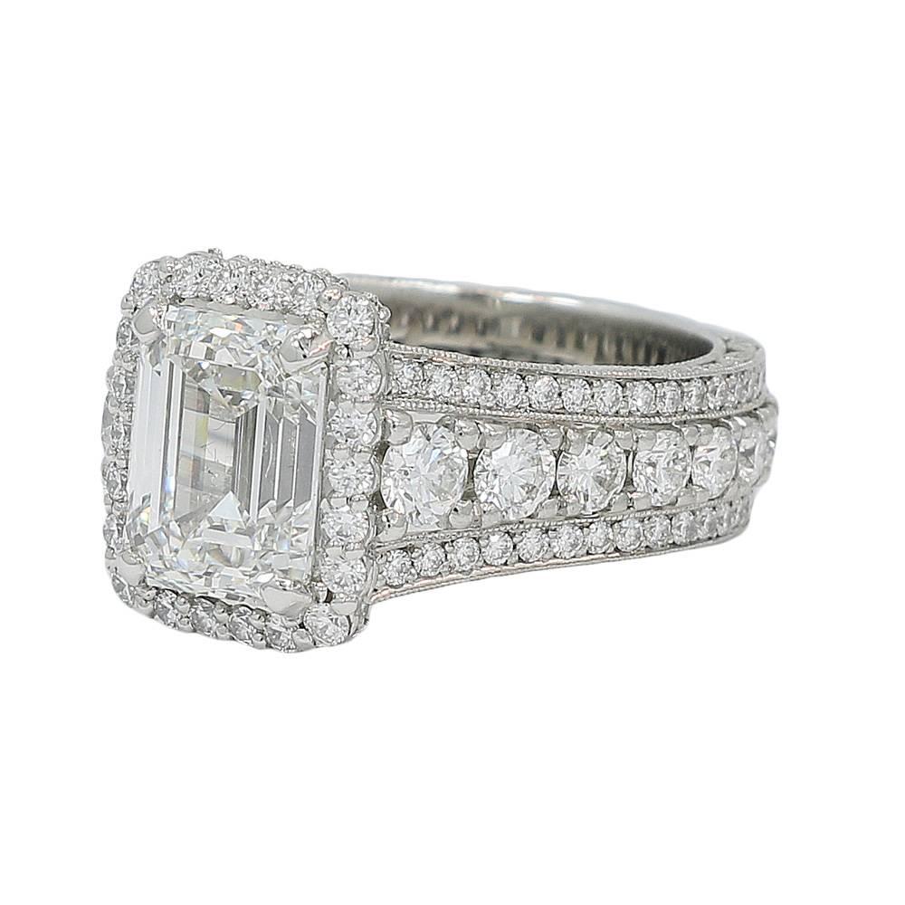 Platinum Tacori diamond ring. The emerald cut diamond H-VS2 in color and clarity weighs 4.04 carats total weight. The round brilliant cut diamonds weigh approximately 3.00 carats total weight. The ring sits at a size 7.5 and weighs a total of 18.8