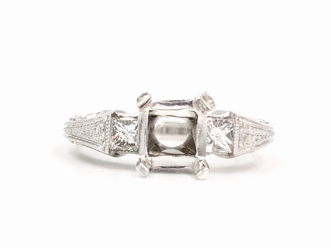 *Setting will not include a center stone*
A timeless three stone style engagement ring mounting created by Tacori. Solid platinum setting features two beautiful princess cut side stones at .33 carats total weight, approximately F color, VS2 clarity.