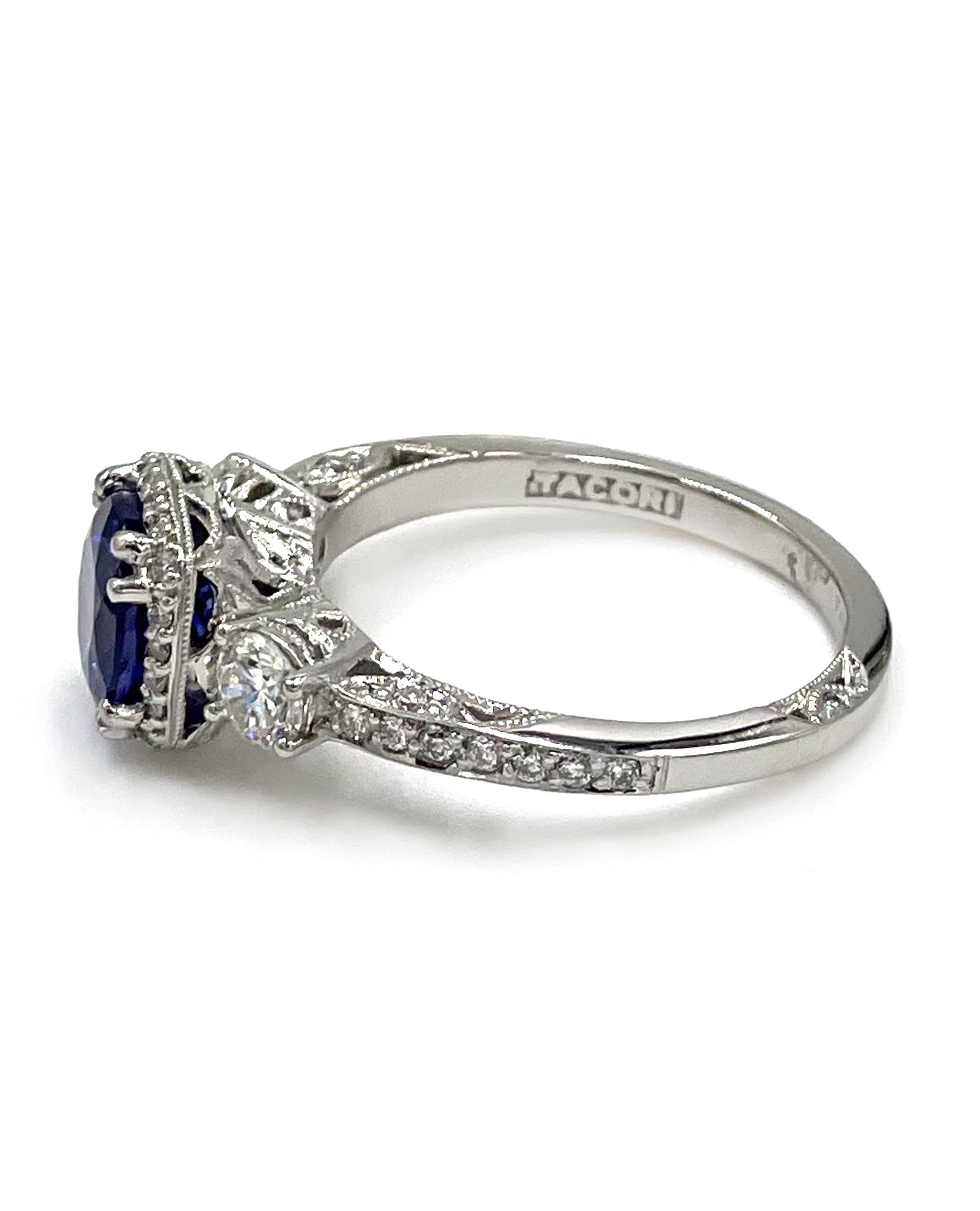 Tacori platinum“Dantela” Collection three stone ring with diamonds totaling 0.68 carats (G Color, VS Clarity) and one center round, brilliant-cut tanzanite totaling 1.59 carats.

- Style no. 2623RDMDP
- Finger size 6.5
- Comes with original Tacori