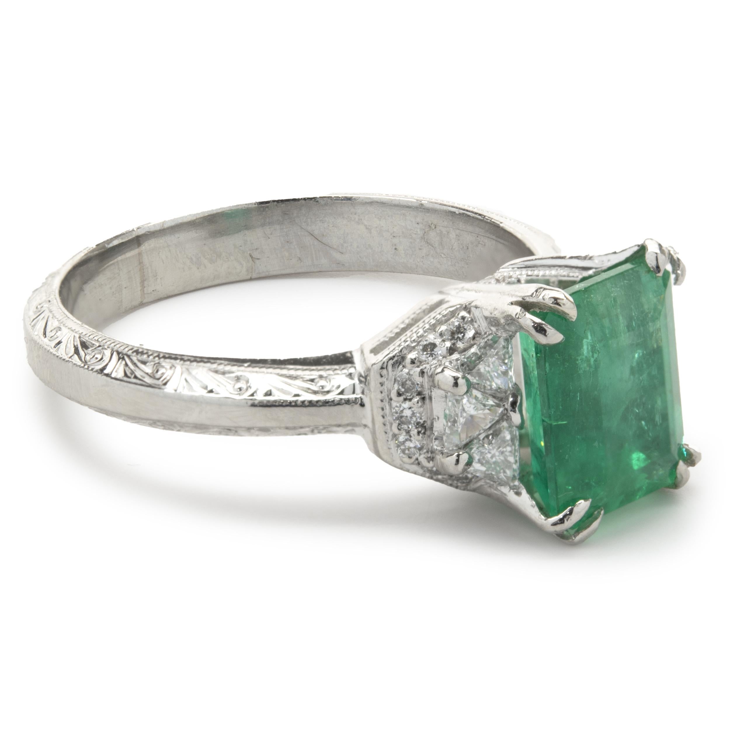 Designer: Tacori
Material: platinum
Emerald: 1 emerald cut = 1.88ct
Color: Kelly Green
Clarity: AAA
Diamond: 6 trillion cut = 0.60cttw
Color: H
Clarity: SI1
Diamond: 14 round cut = .07cttw
Color: G / H
Clarity: SI1
Dimensions: ring top measures