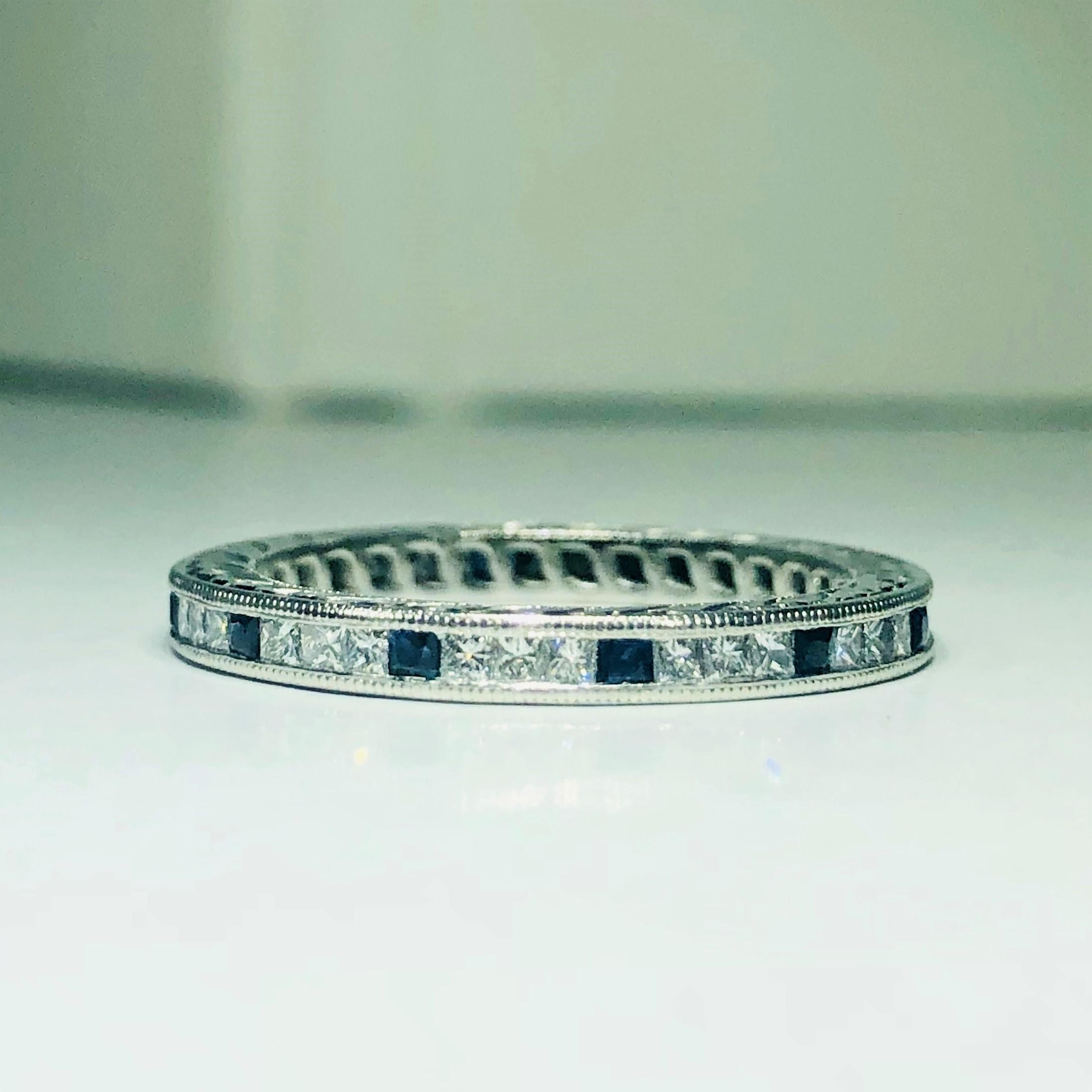 Tacori platinum princess cut diamond and sapphire eternity band. This designer Tacori creation is a unique and exquisite piece, embodies the Tacori reputation. This is a platinum eternity band, weight 3.9 grams. The ring is adorned with 12 princess