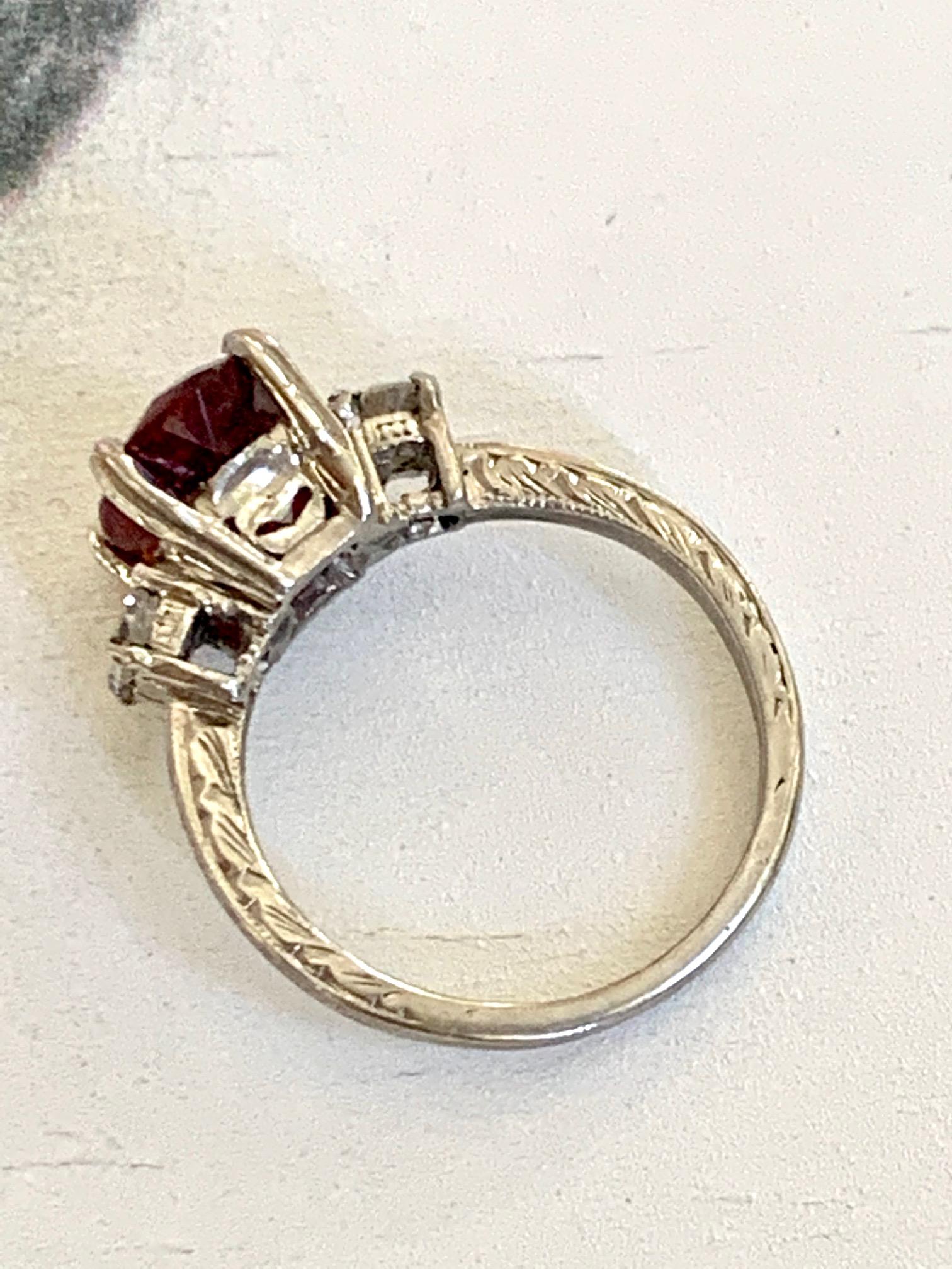 This beautiful Tacori ring features a red faceted Rubellite Tourmaline center stone, accented by two 3.5mm Brilliant cut side Diamonds totaling approximately .35 ctw. Clarity and color: SI(1)-G. 

The Rubellite stone measures 9mm x 7mm and is