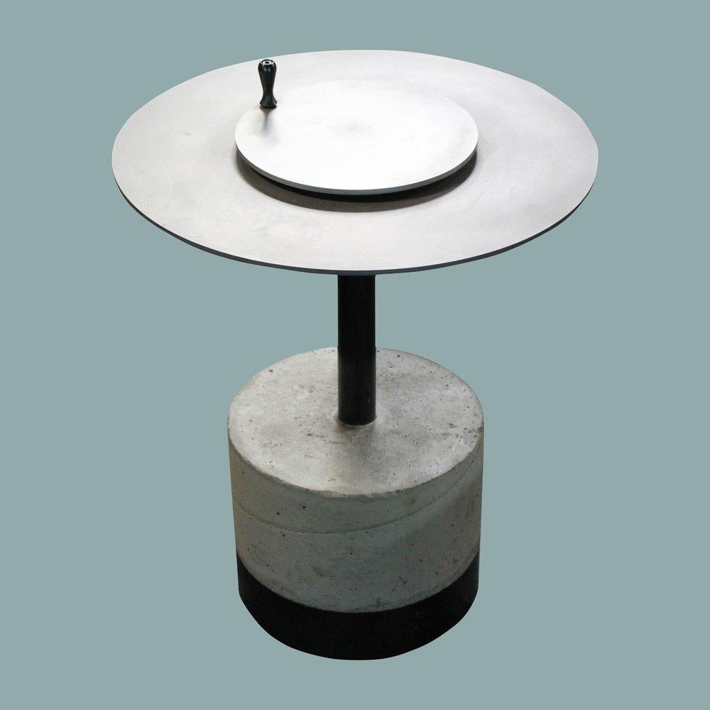 Designed by Basile Built, renowned Design-Fabrication Studio based in San Diego, California, this side table features a hot rolled steel top with an adjustable height center piece and sits on a concrete cast and metal heavy duty pedestal base.
