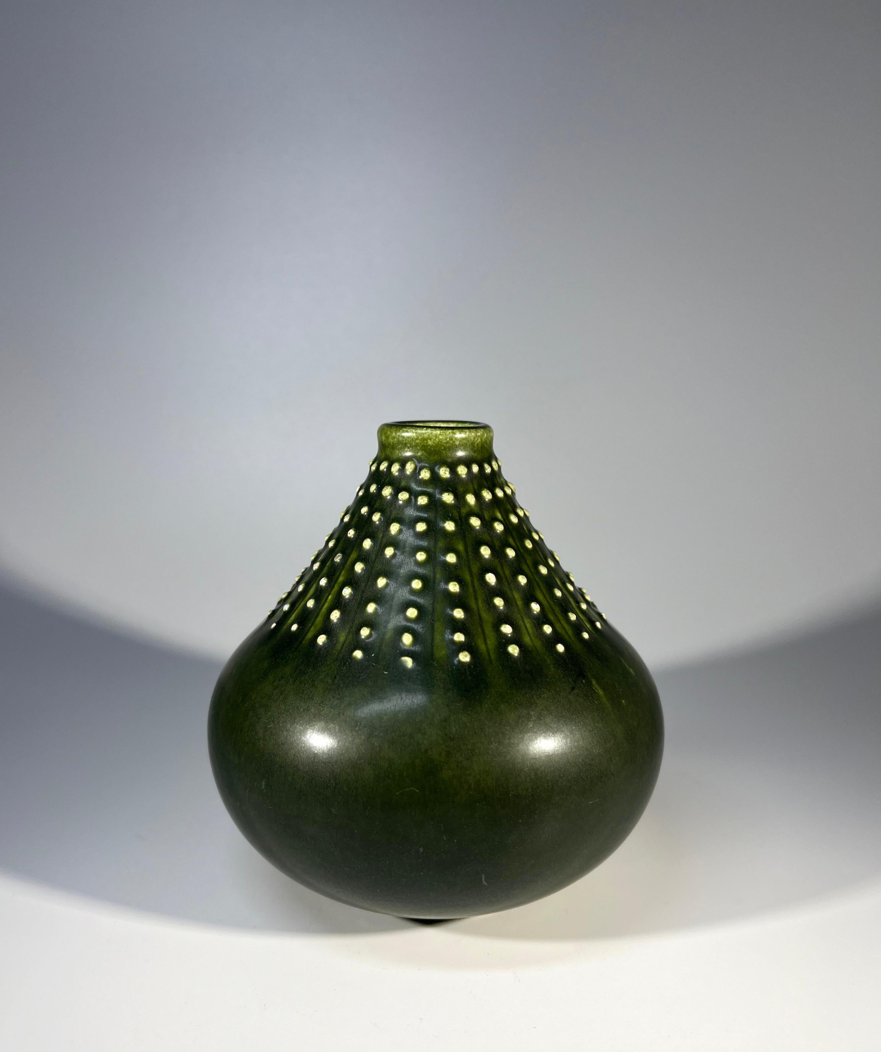 Tactile and effective in design, ceramic vase attributed to Dietlinde Hein for Knabstrup, Denmark
Dark forest green glaze, accentuated with a collar of cream  studs
Circa 1960-65
Signed Knabstrup, Denmark to base
Height 4.25 inch, Diameter 4.25
