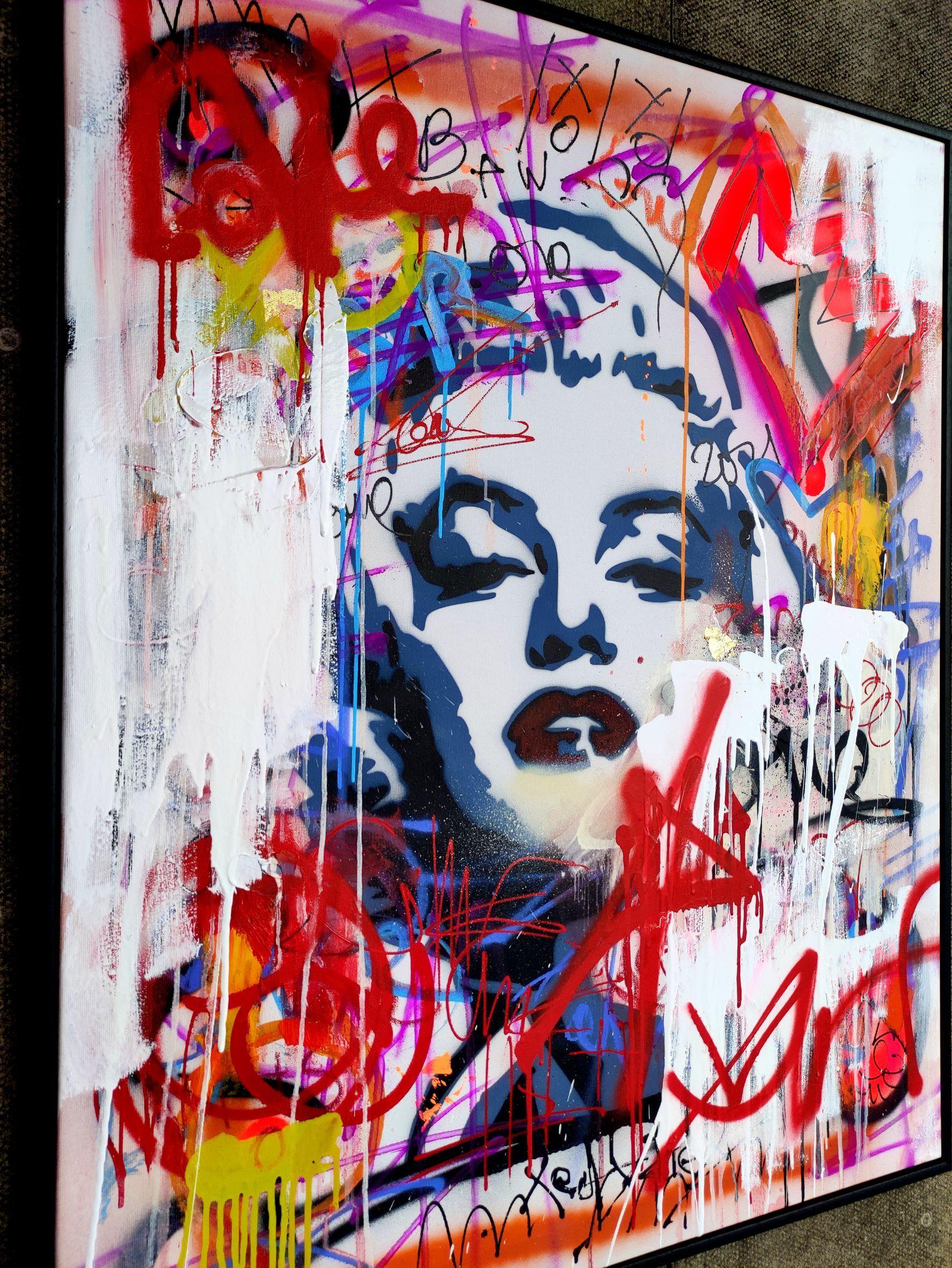 Billboard on the wall in a cosmopolitan city. Different artists overlay their works in layers to create billboard artwork. The stencil work of Marilyn Monroe as the background of this work as the main idea of the composition of 