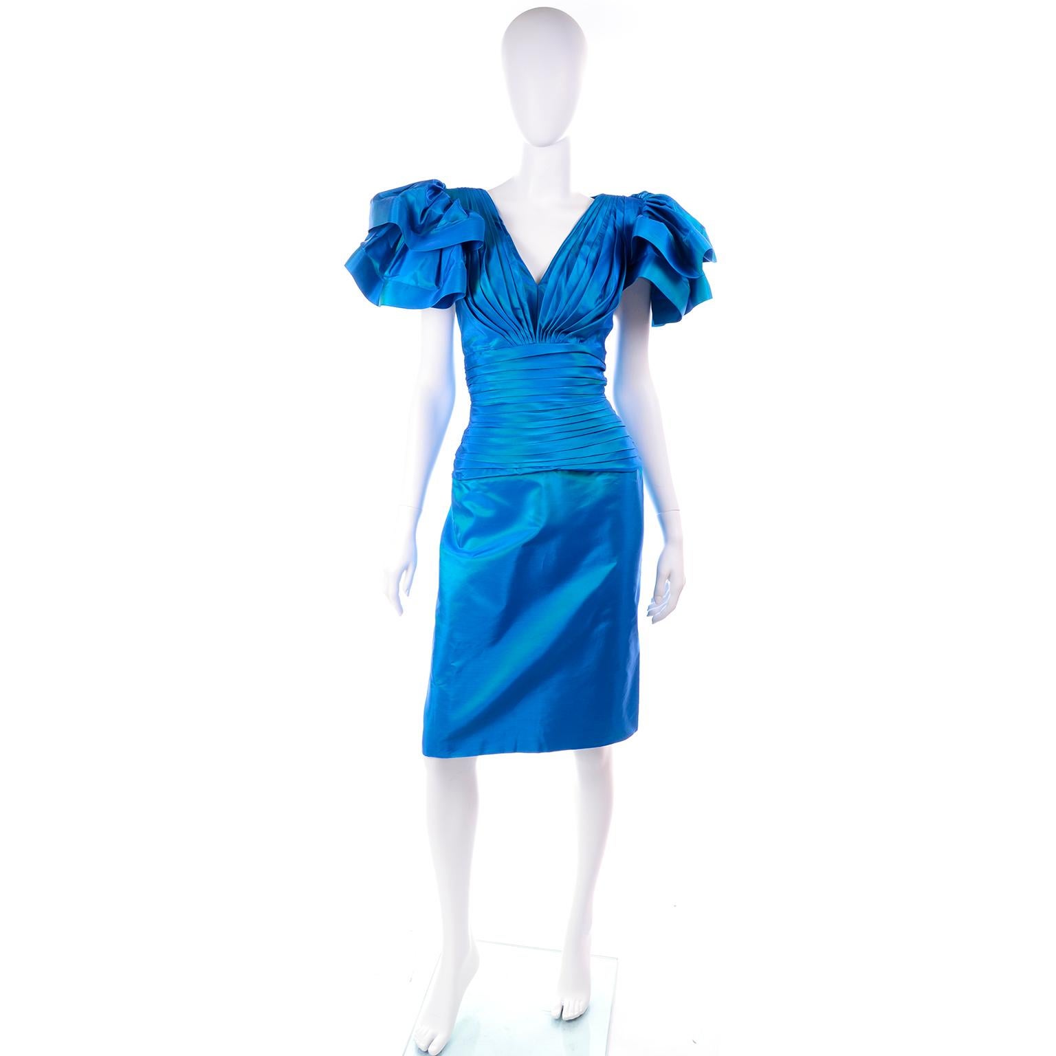 This is a dramatic vintage 1980's iridescent blue green evening dress from Tadashi. The dress was made in the USA and though it is marked a vintage size 10, it fits more like a modern day size 6/8.There is a YKK metal zipper down center back seam,