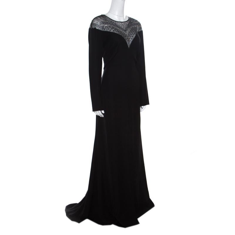 Spectacular gowns are what Tadashi Shoji brings out year after year and this black creation is no exception! It is made of 100% polyester and features a gorgeous bodice detailing with embellished studs and stones. It flaunts a round neckline, long