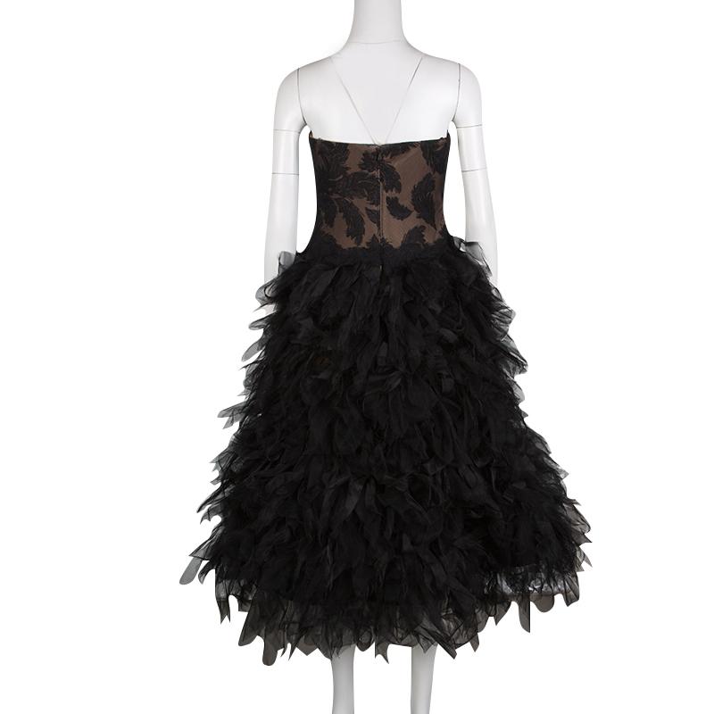 Tadashi Shoji's Fall-Winter collection of 2015 was all about floating, aerial dresses with a sense of flight. A part of the collection, this black strapless dress comes with an embroidered bodice and beautifully feathered, tulle bottom. This