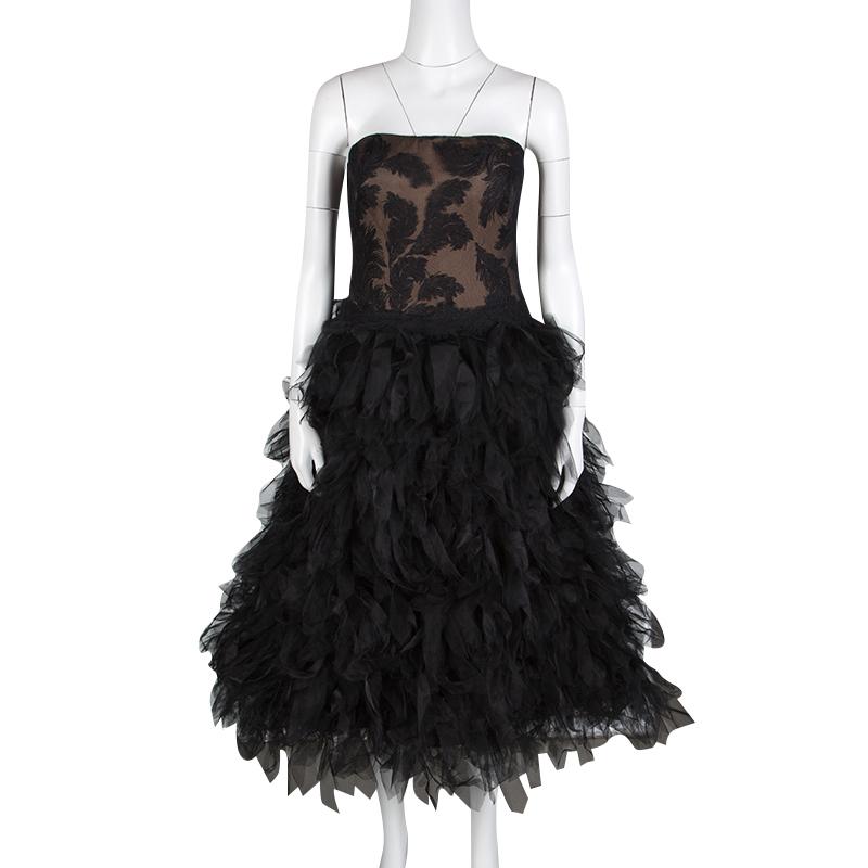 Tadashi Shoji's Fall-Winter collection of 2015 was all about floating, aerial dresses with a sense of flight. A part of the collection, this black strapless dress comes with an embroidered bodice and beautifully feathered tulle. This flattering