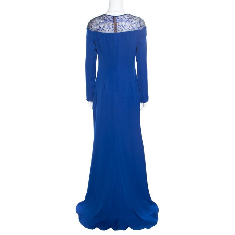 Spectacular gowns are what Tadashi Shoji brings out year after year and this blue creation is no exception! It is made of polyester and features a gorgeous bodice detailing with embellished studs and stones. It flaunts a round neckline, long sleeves
