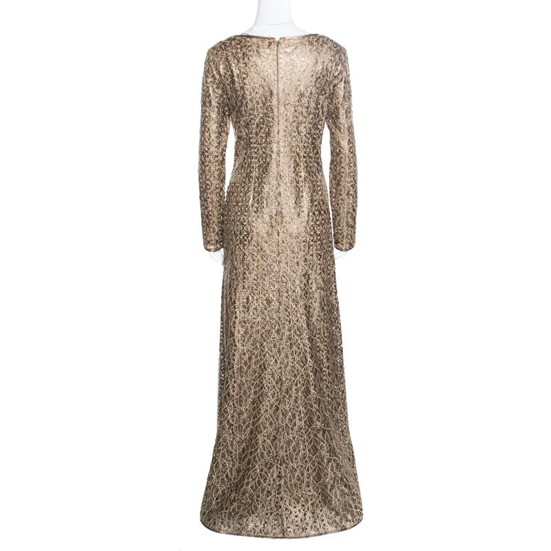 A glamorous and red carpet ready outfit, this Tadashi Shoji boat neck gown will never let you down. Constructed in a gold laser cut fabric, this gown has long sleeves and a fabulous silhouette that creates the most stunning feminine and elegant